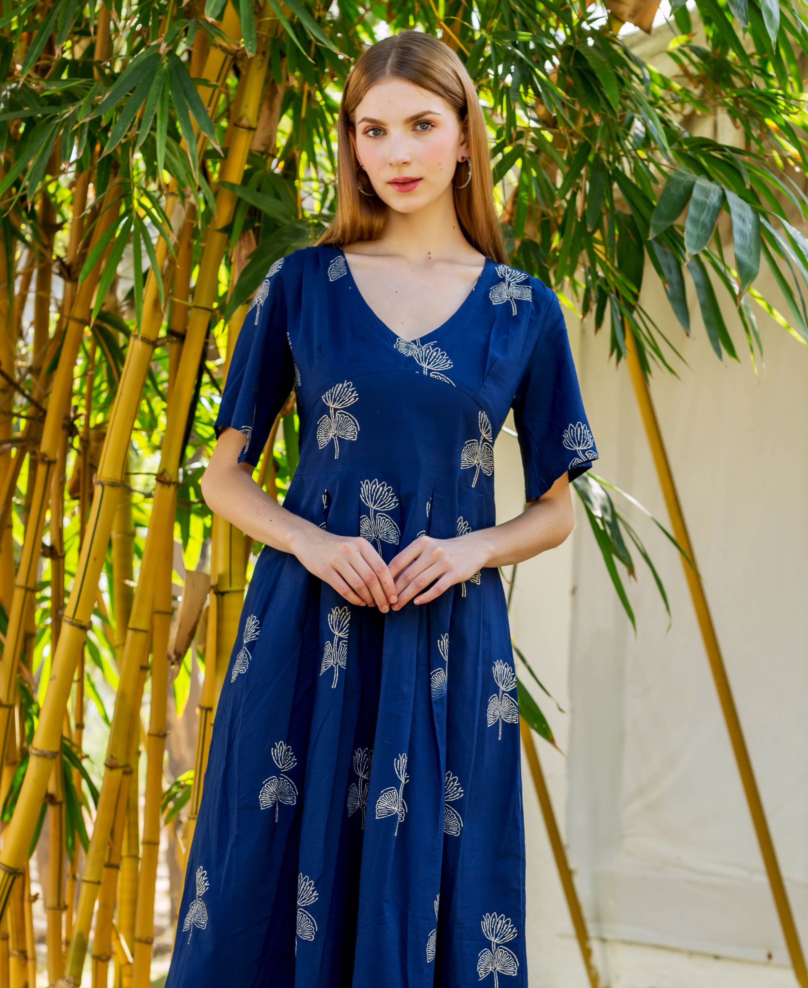 Front view of indigo Ayesha dress, hand-block-printed with white floral motifs, on model.