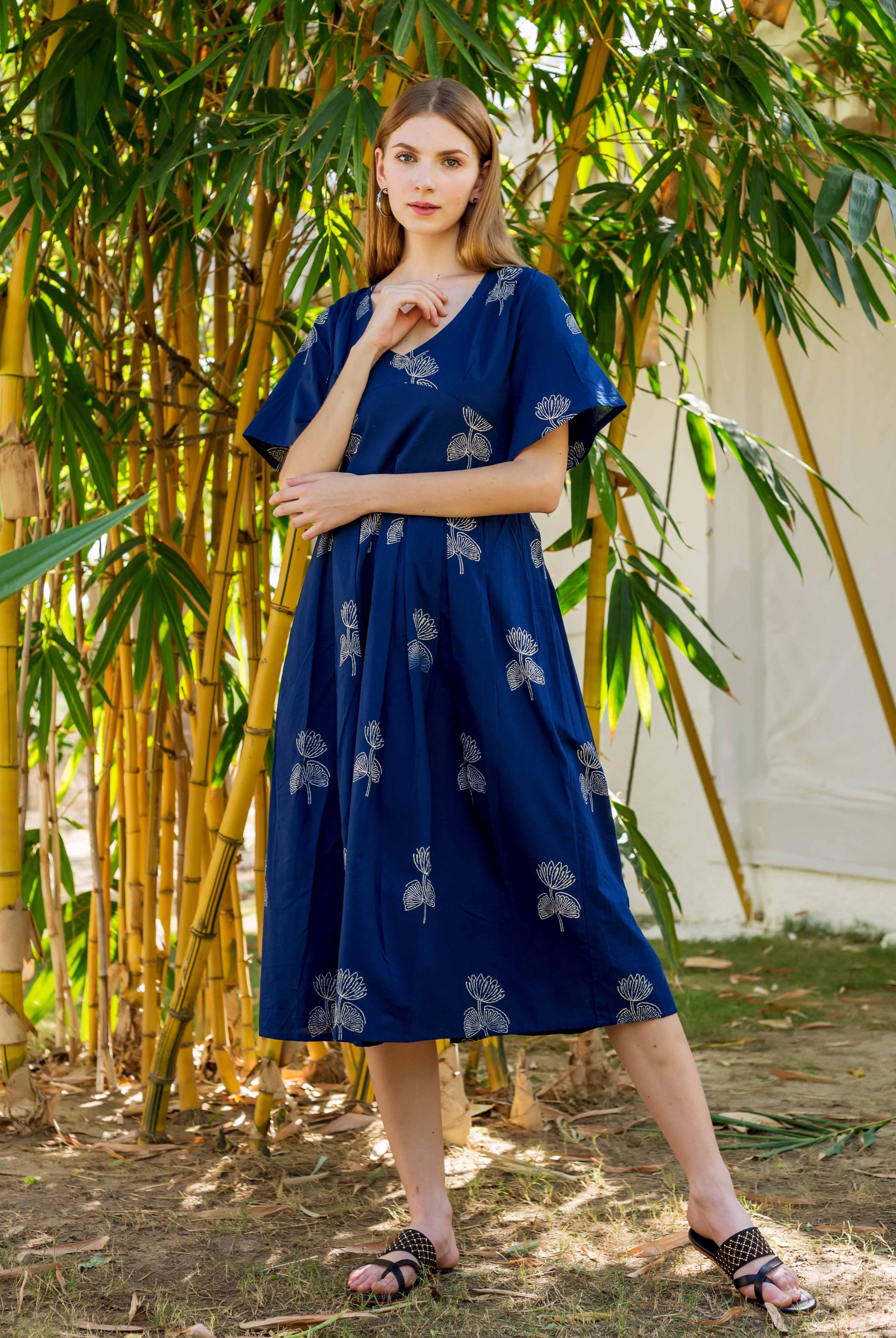 Model wears an indigo Ayesha dress with white hand-block-printed floral motifs.