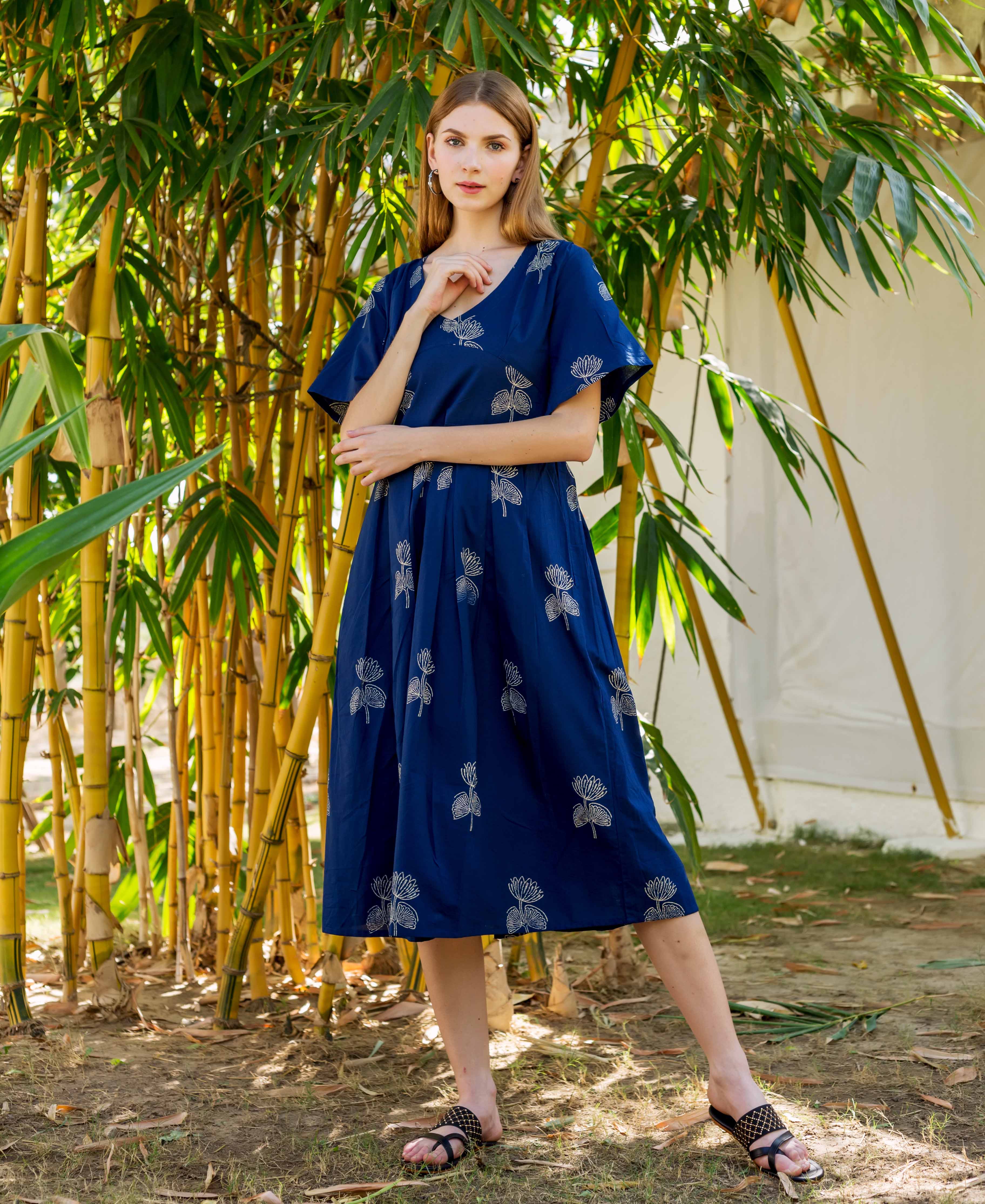 Model wears an indigo Ayesha dress with white hand-block-printed floral motifs.