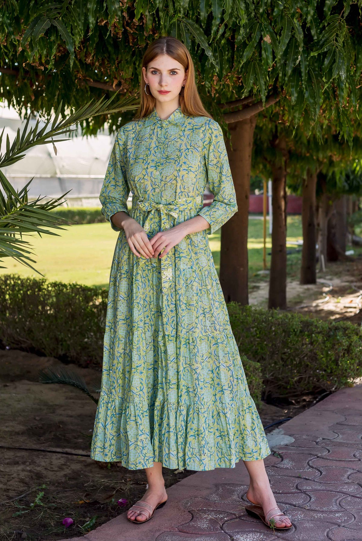 Full-length shot of a model wearing a lime green hand-block-printed shirt collar tiered dress.