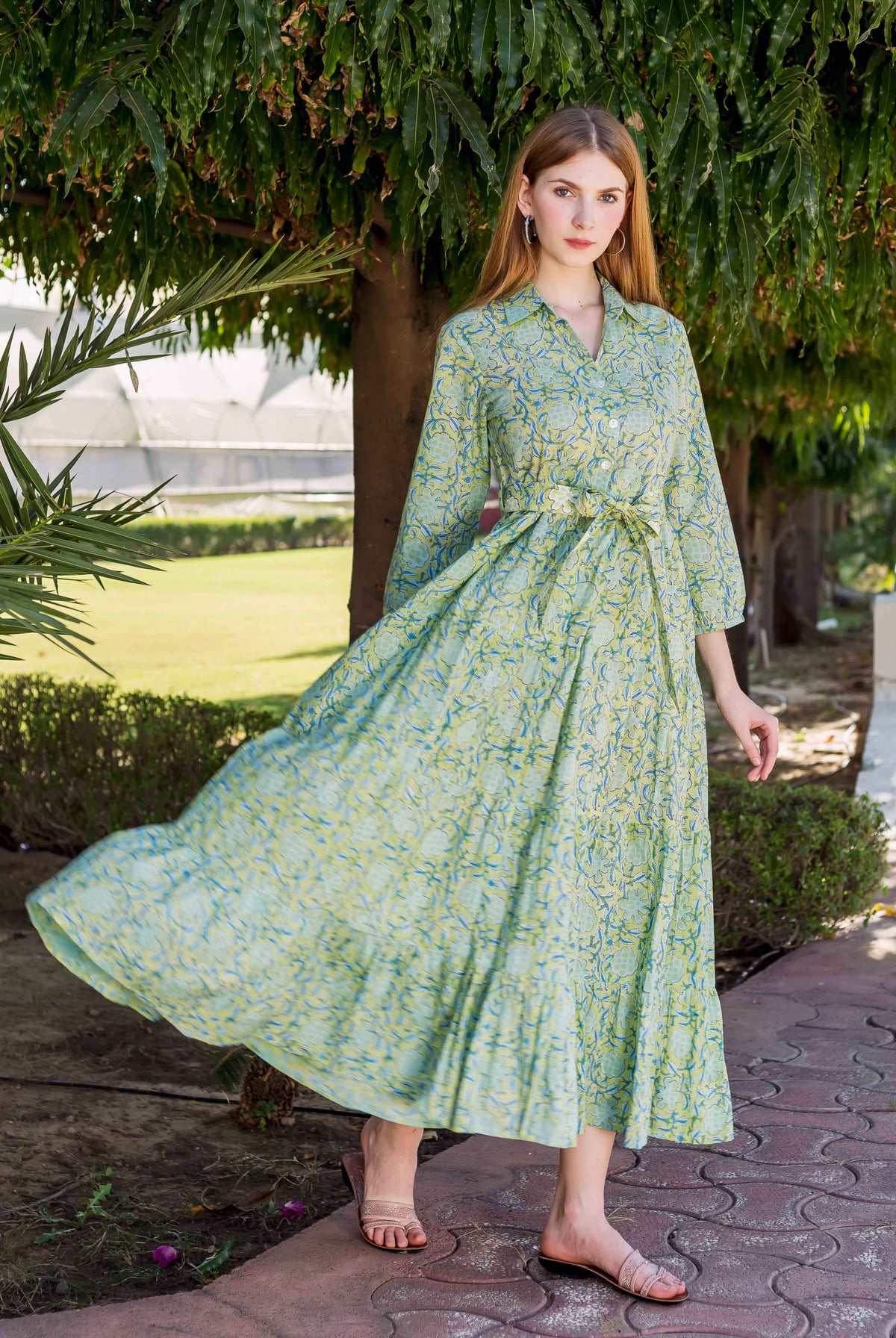 Model in a flowing lime green shirt collar dress featuring subtle missprint block patterns.