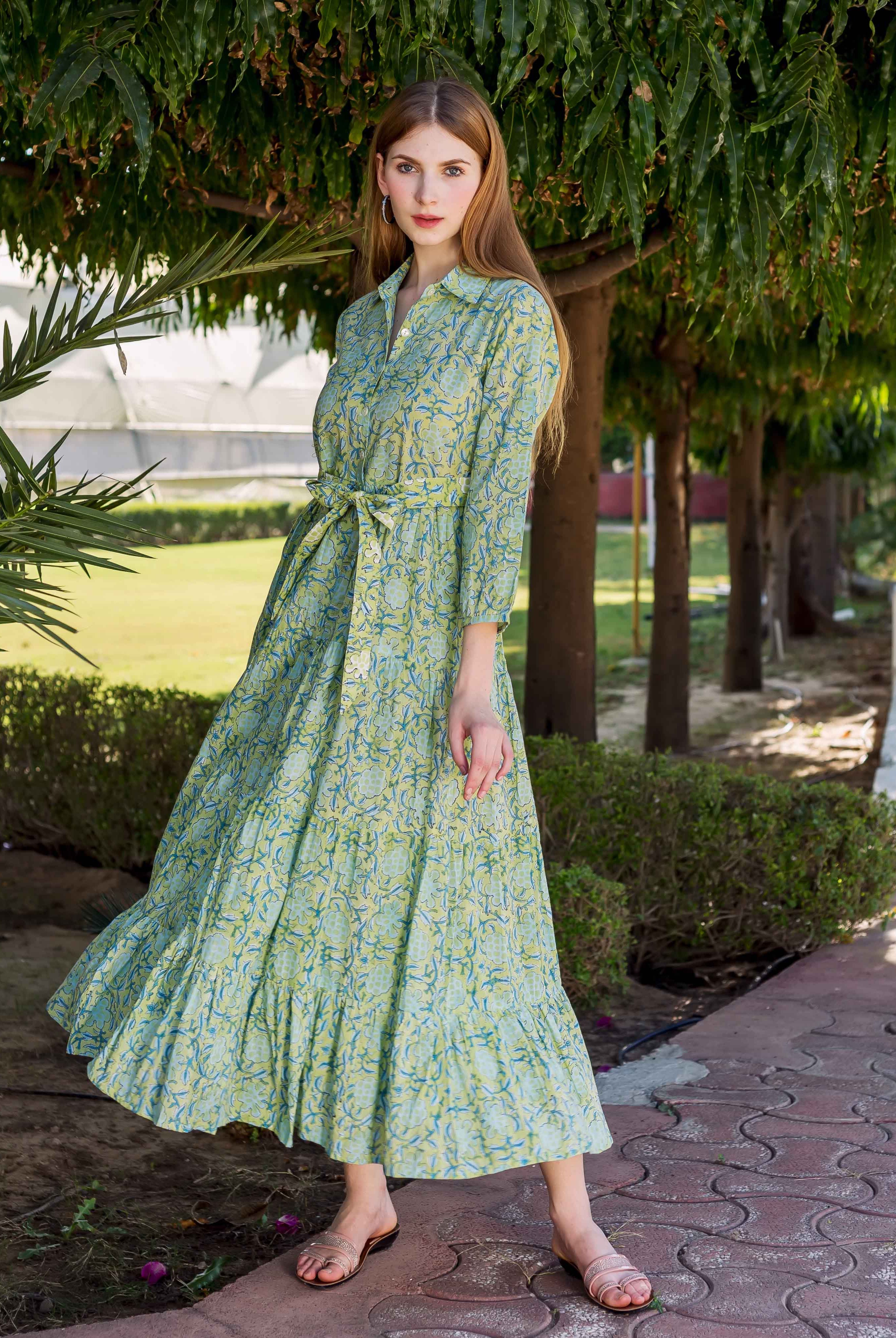 A model wearing a lime green, blue, and yellow hand-block-printed dress.