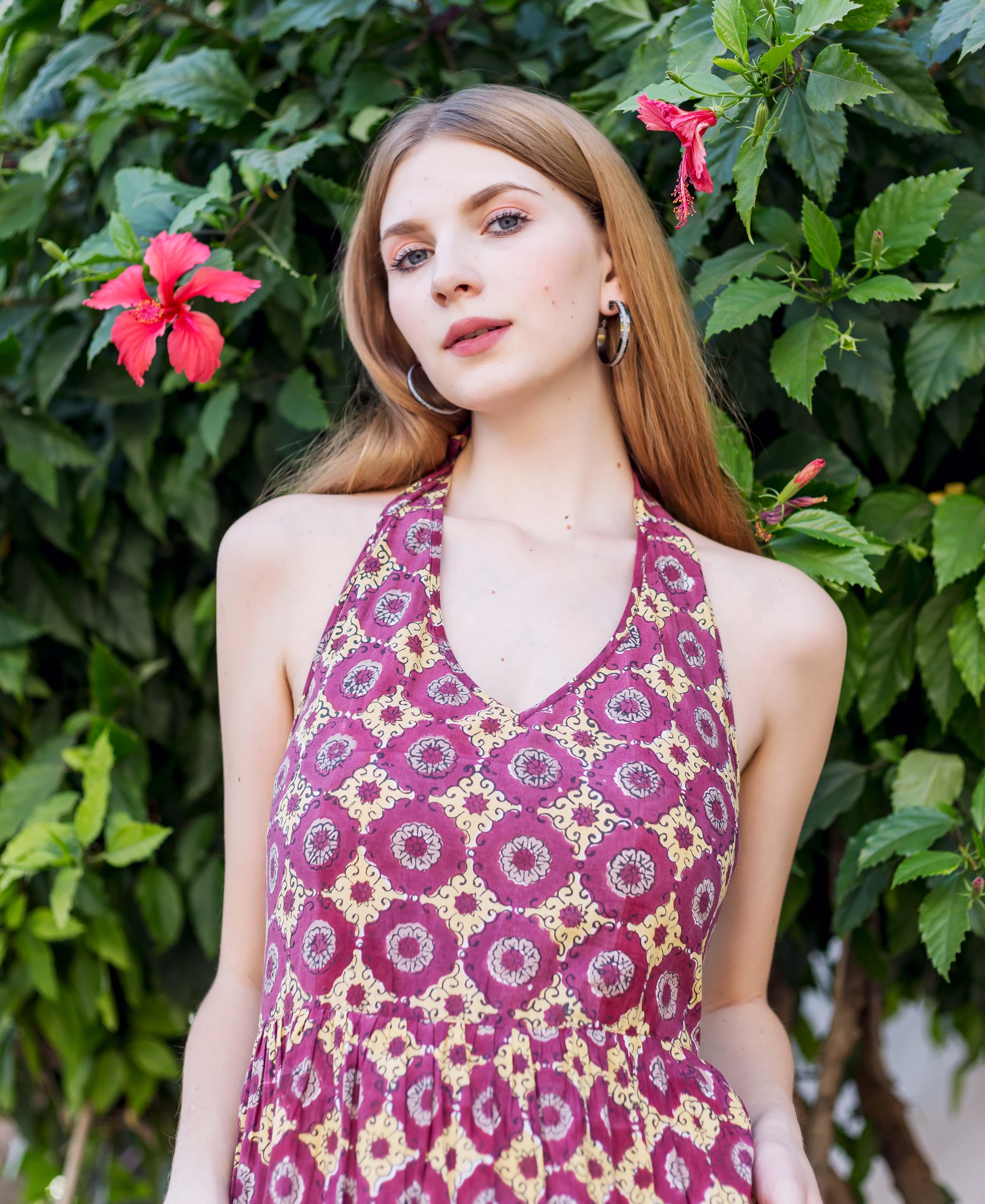 Front-facing model in a wine halter neck dress with yellow hand-block-printed ethnic pattern.