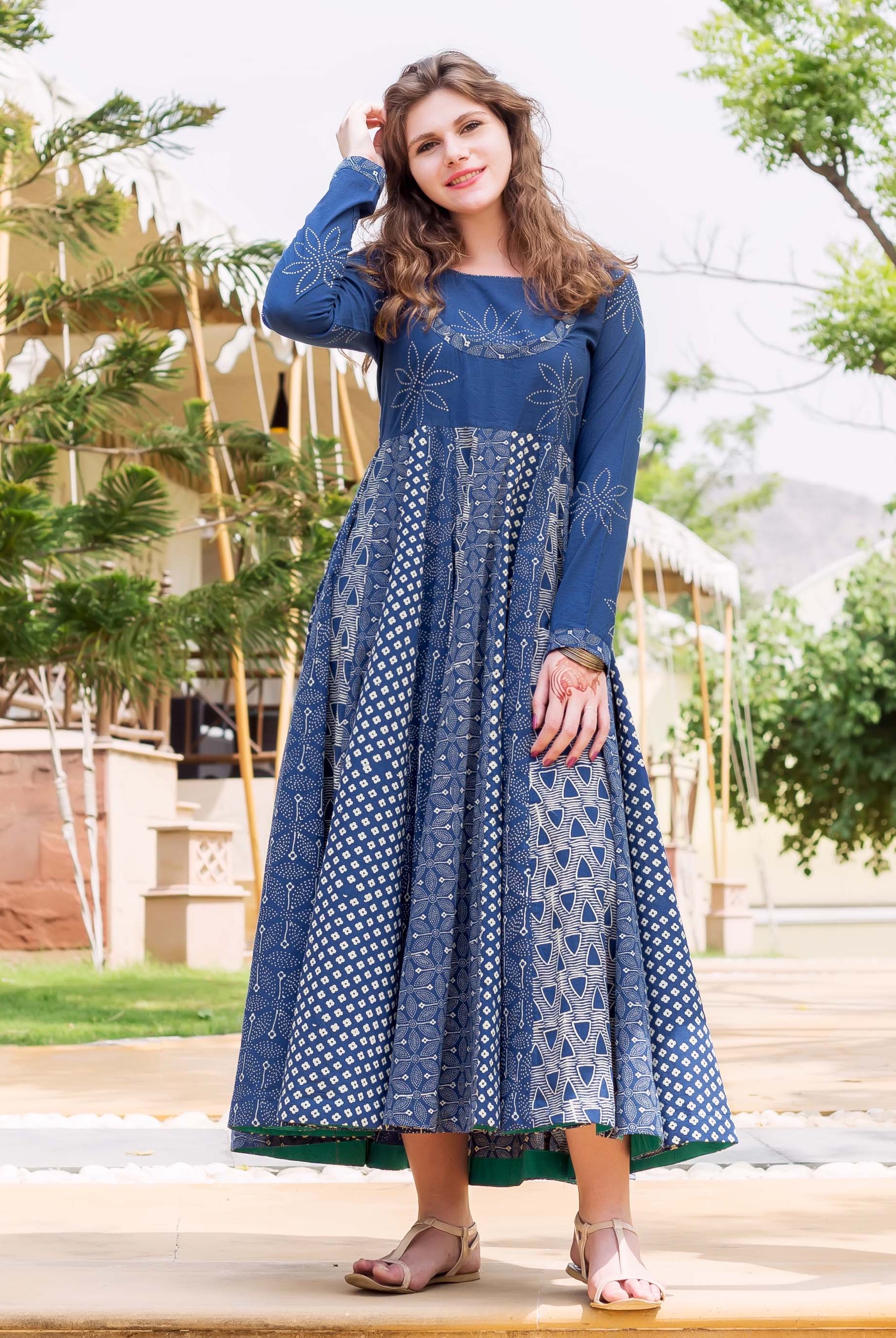 Front view of a model wearing an indigo and white hand block printed flared long dress.