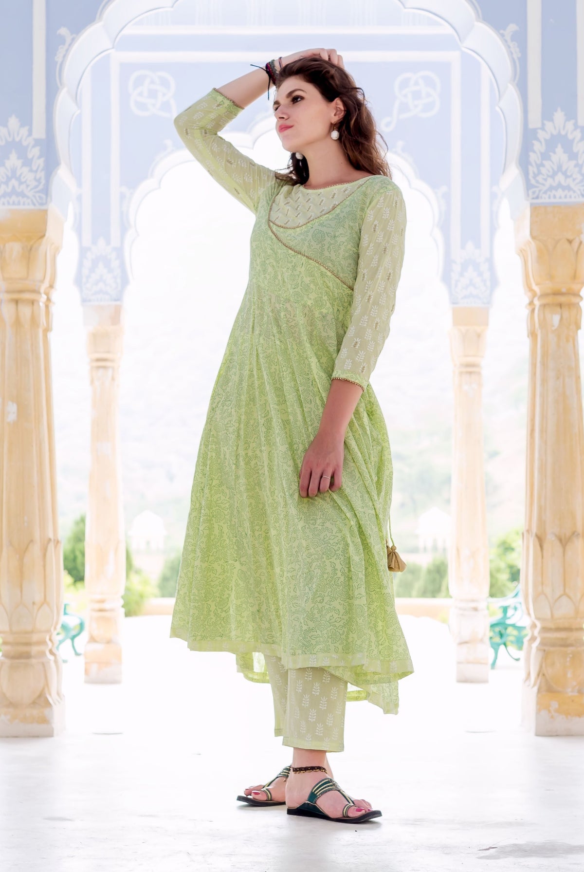 Model in lime green hand block printed Anarkali kurta set with delicate embroidery.