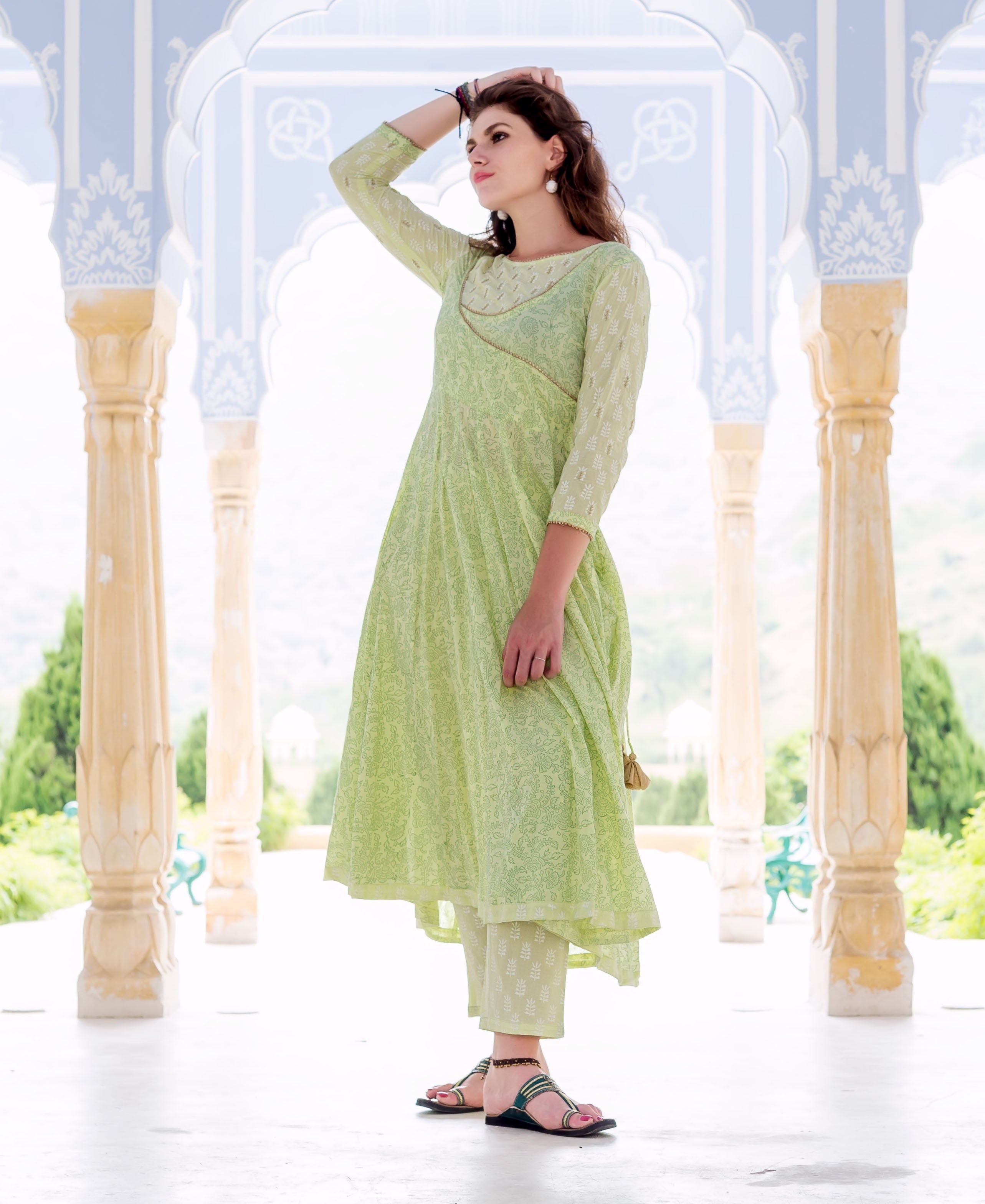 Model in lime green hand block printed Anarkali kurta set with delicate embroidery.