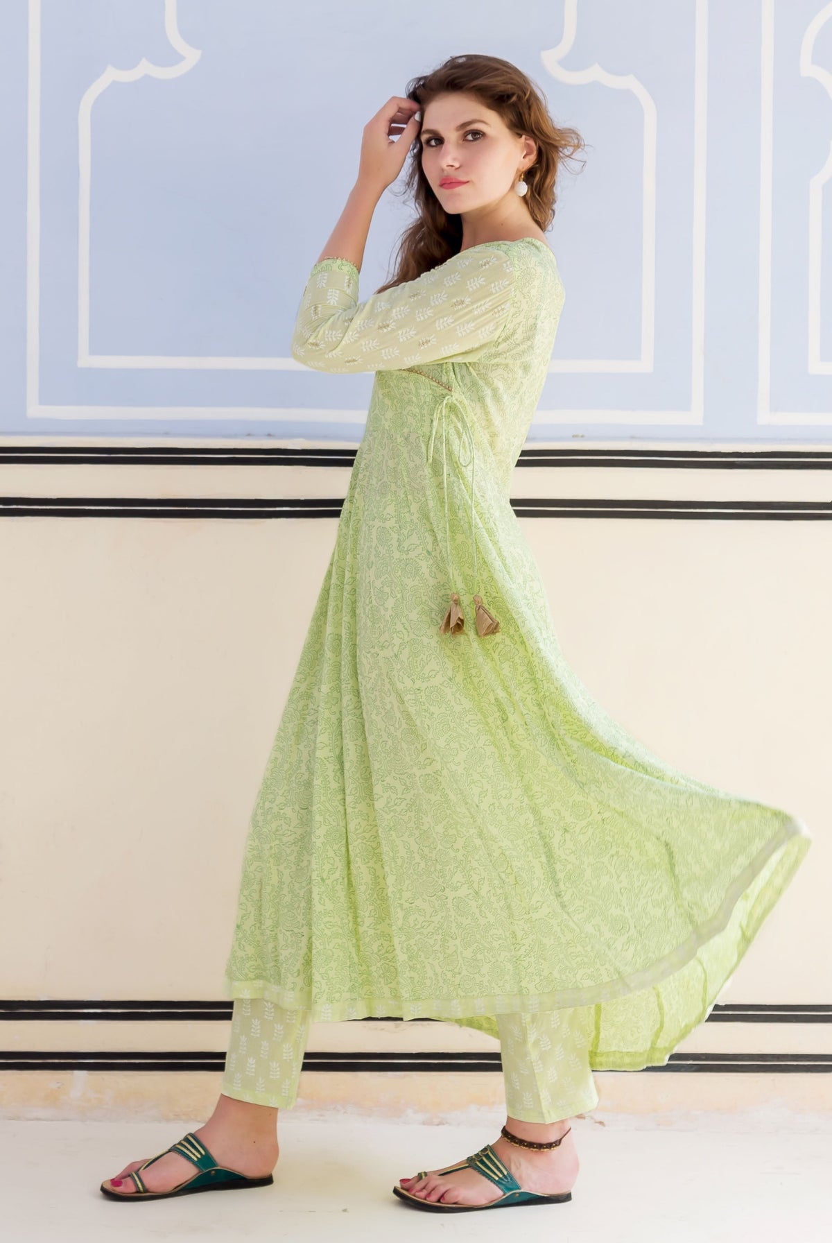 Full-length model in a lime green hand block printed and embroidered Anarkali kurta set.