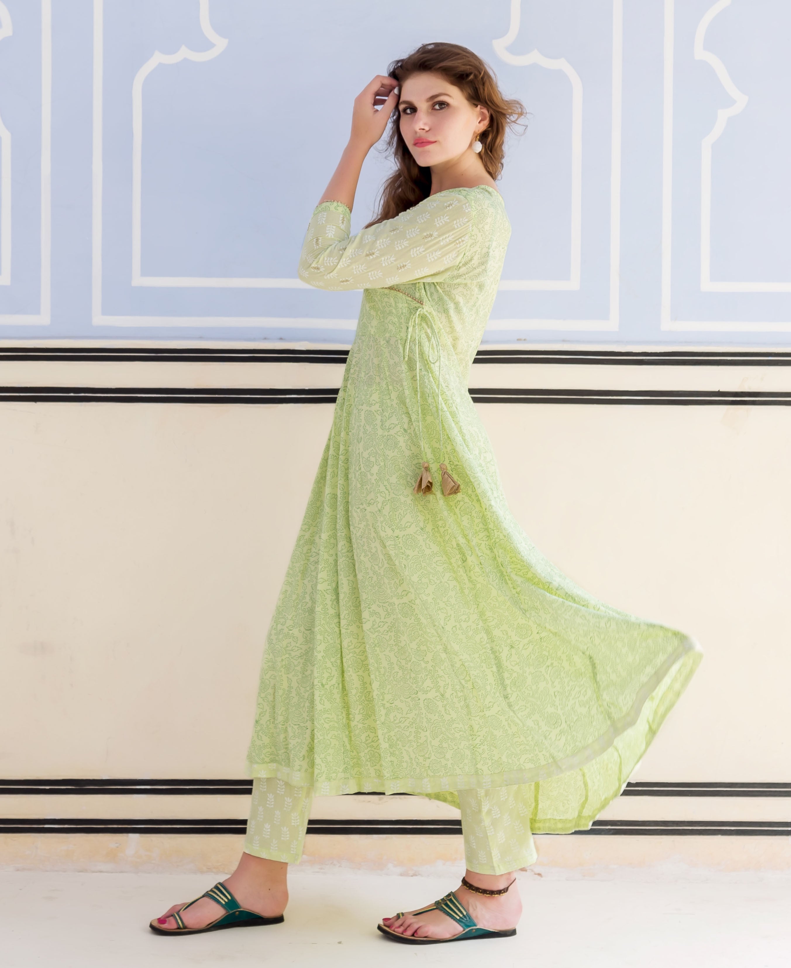 Full-length model in a lime green hand block printed and embroidered Anarkali kurta set.