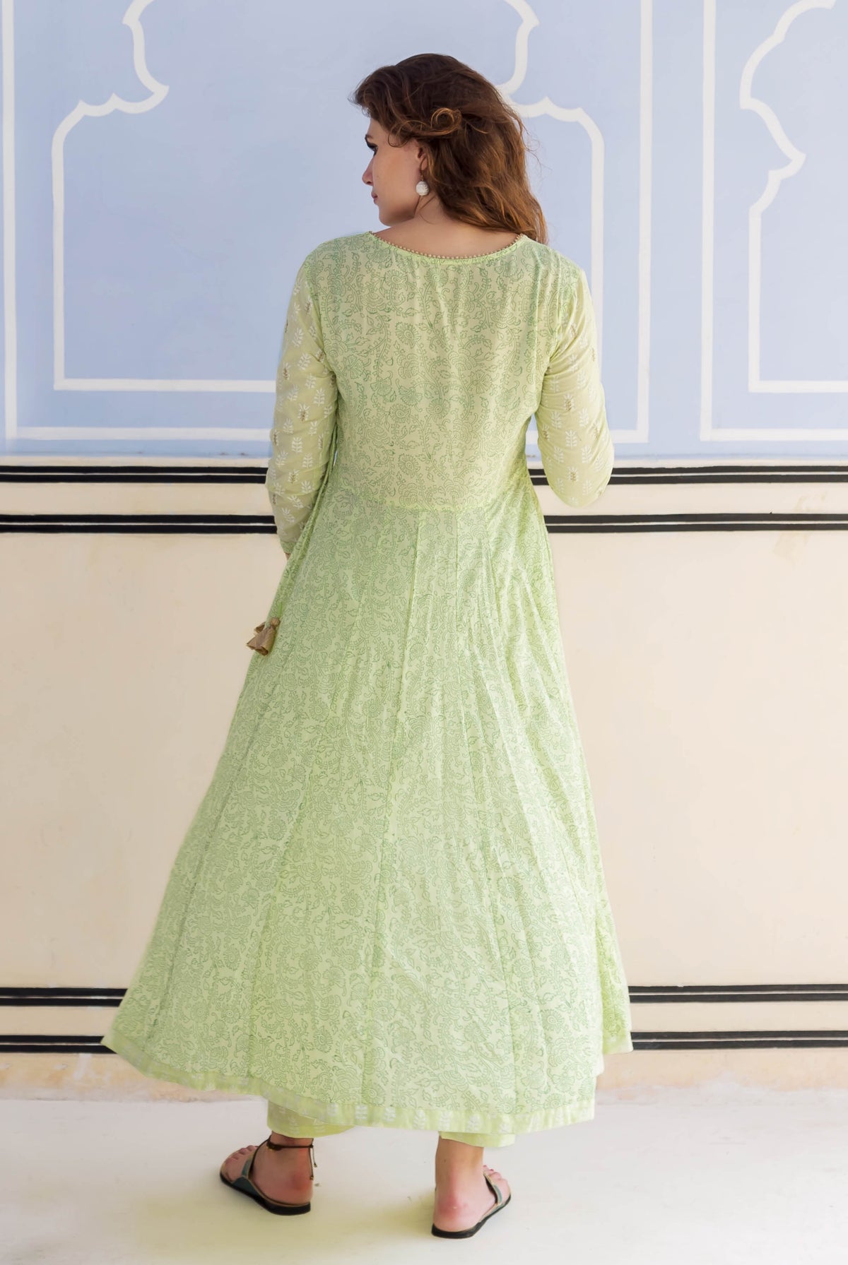 A model wearing a lime green, hand-block-printed and embroidered Anarkali kurta.