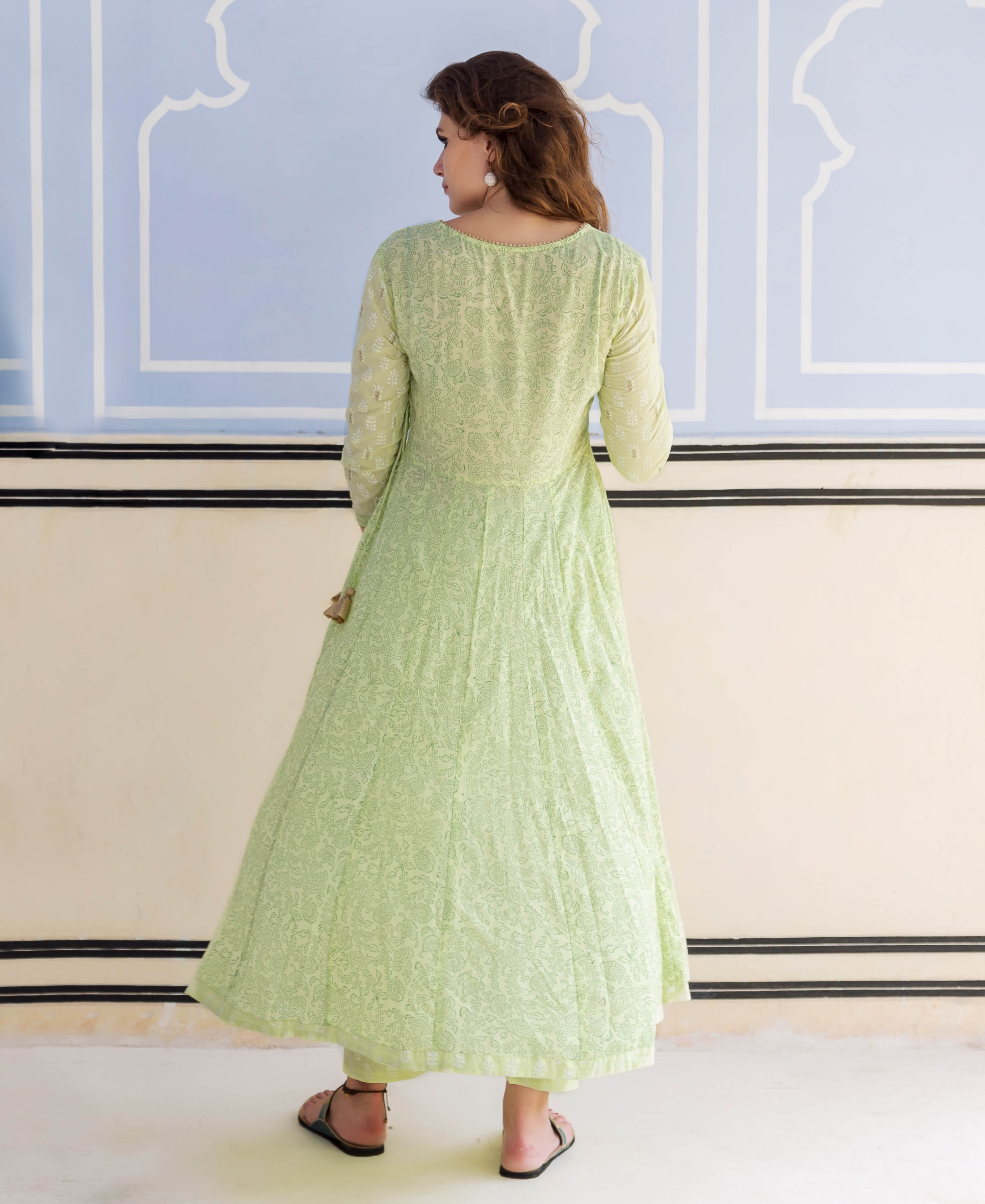 A model wearing a lime green, hand-block-printed and embroidered Anarkali kurta.