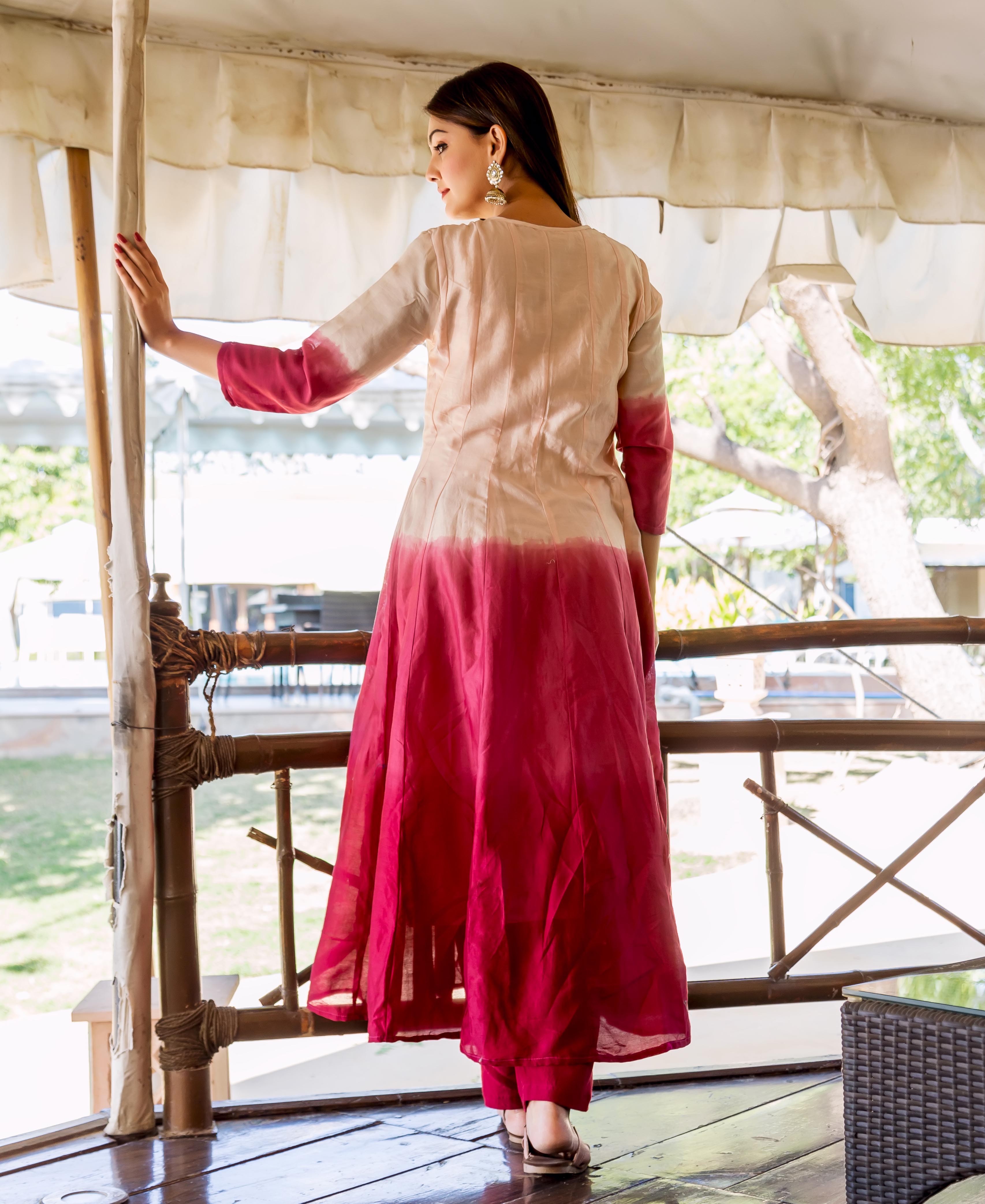 Back view of a model in a salmon and burgundy ombre Anarkali kurta.