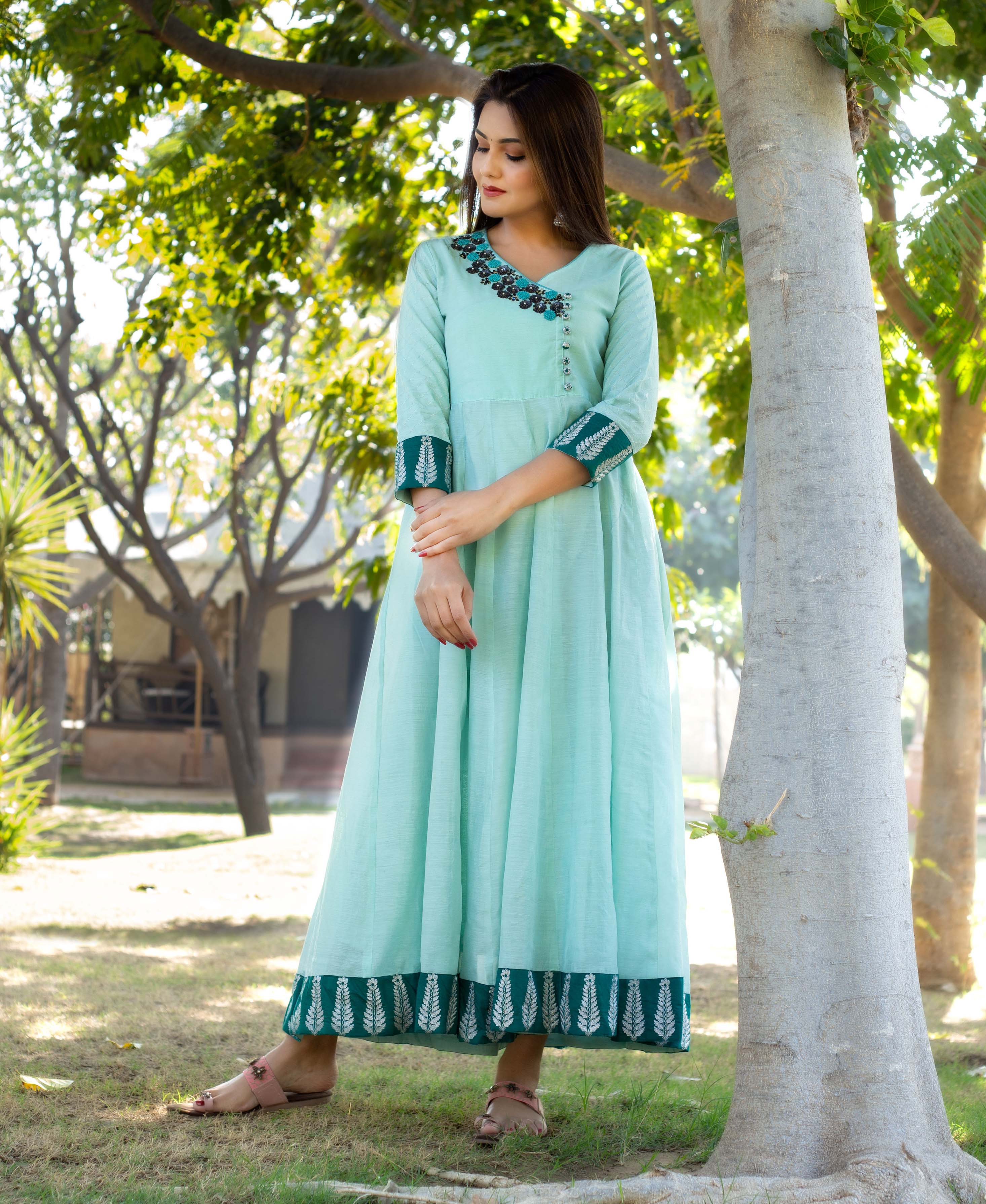 Mint green Angrakha style dress on model, hand-embroidered neckline, block-printed leaf borders.