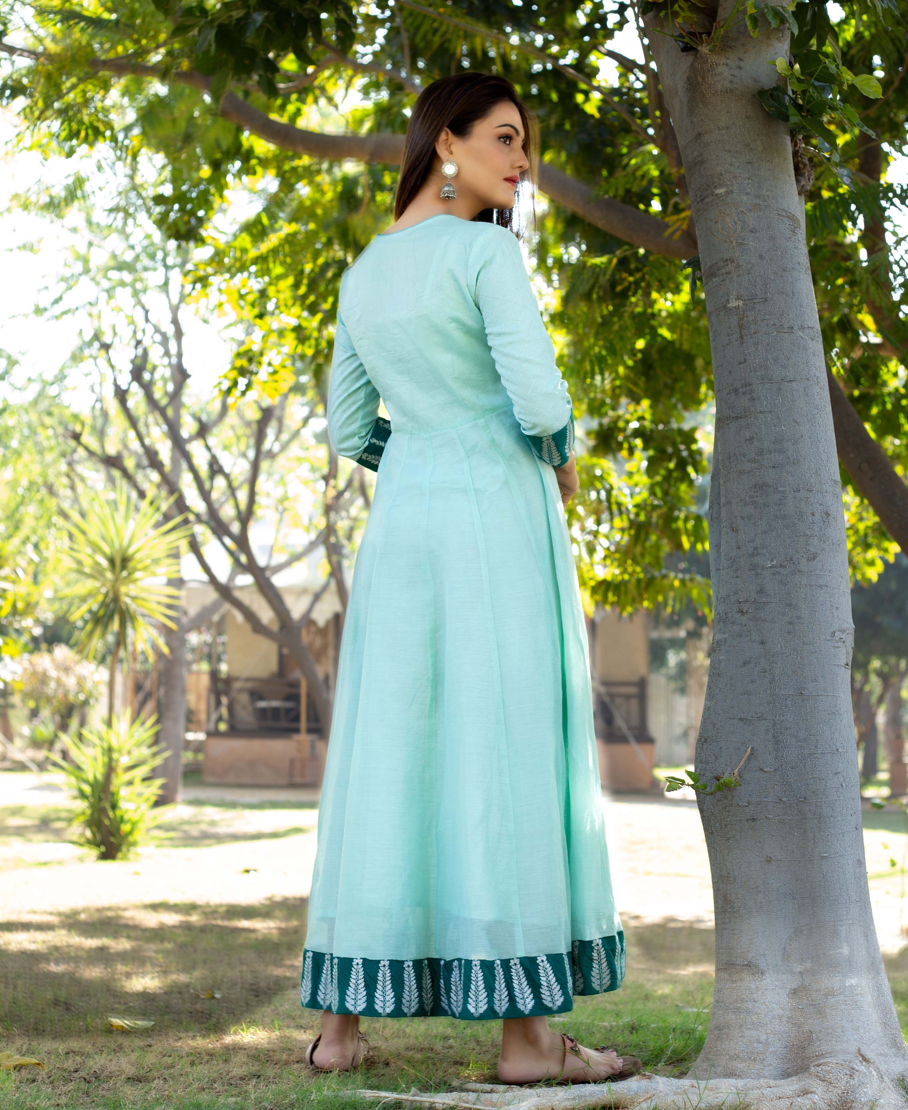 Back view of model in mint green Angrakha dress, hand-block-printed leaf border.