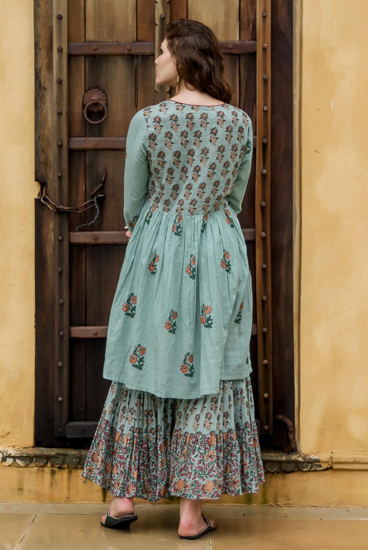 A model wearing a blue floral hand-block-printed kurta and sharara.