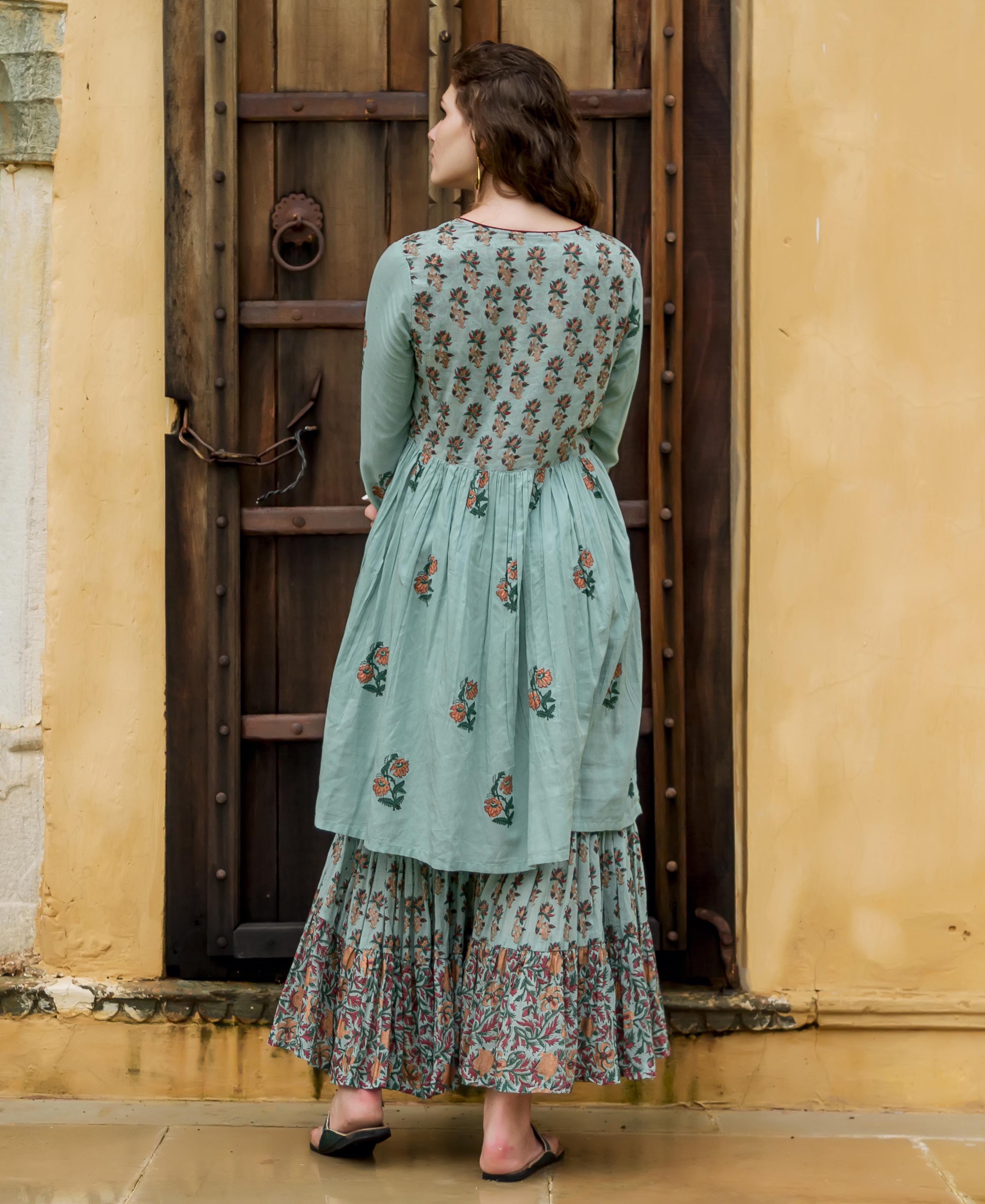 A model wearing a blue floral hand-block-printed kurta and sharara.