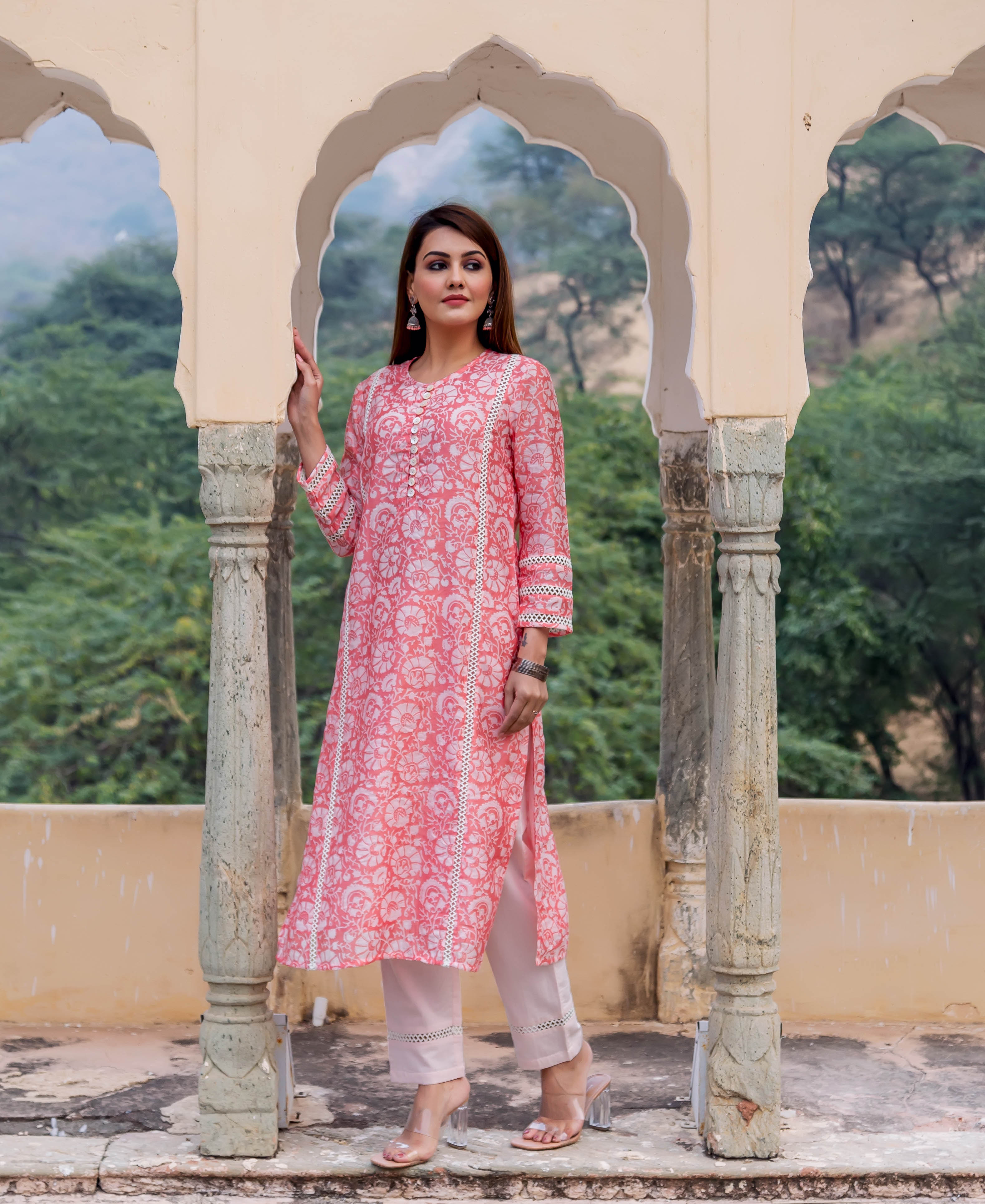 Model wearing a peach kurta with white floral hand block print and lace details.