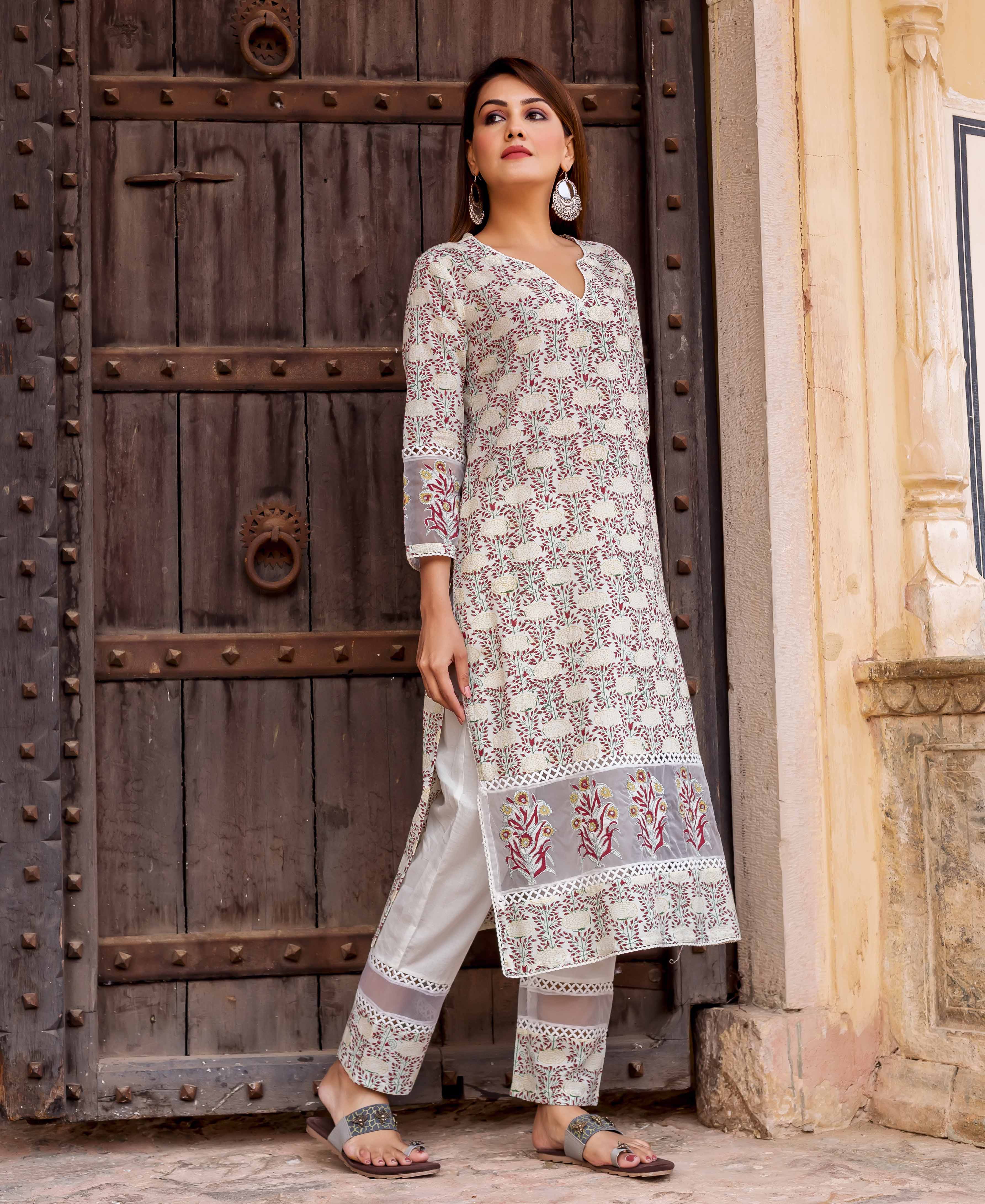 Model in an off-white block-printed floral kurta set with delicate embroidery details.