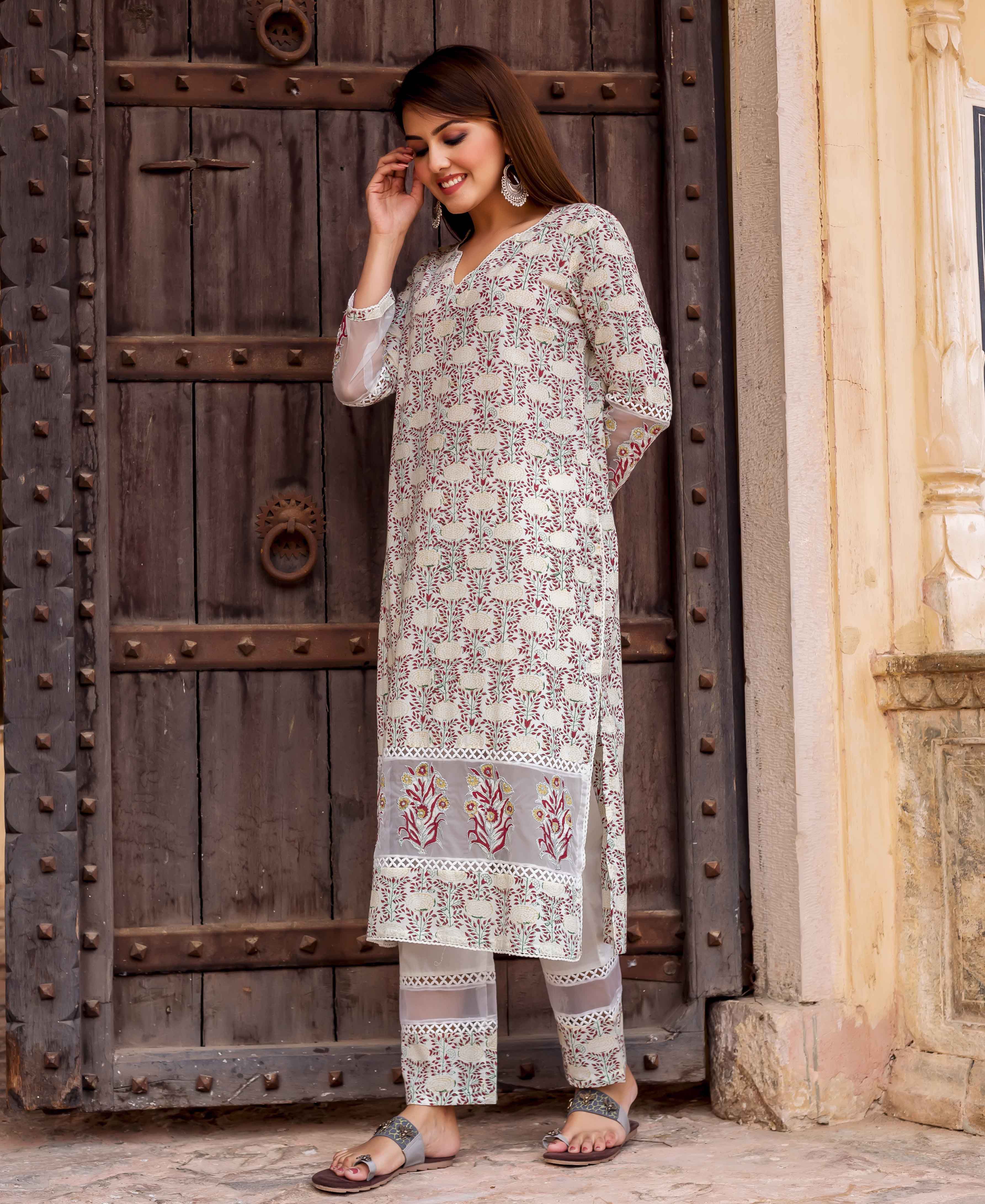 Model in off-white floral block printed kurta set with sheer embroidered panels.