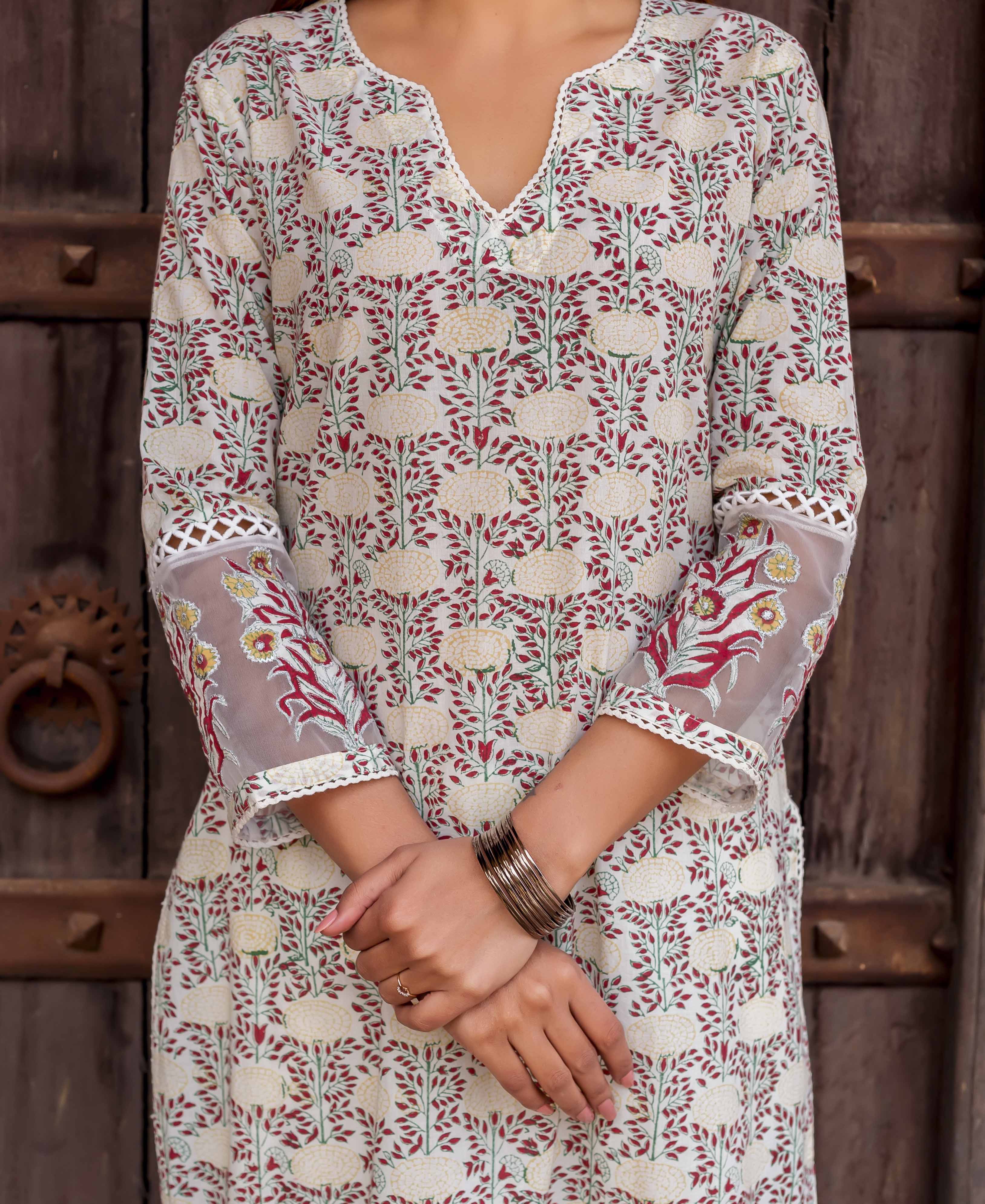 Mid-shot model in cream floral block print kurta with sheer embroidered sleeves.