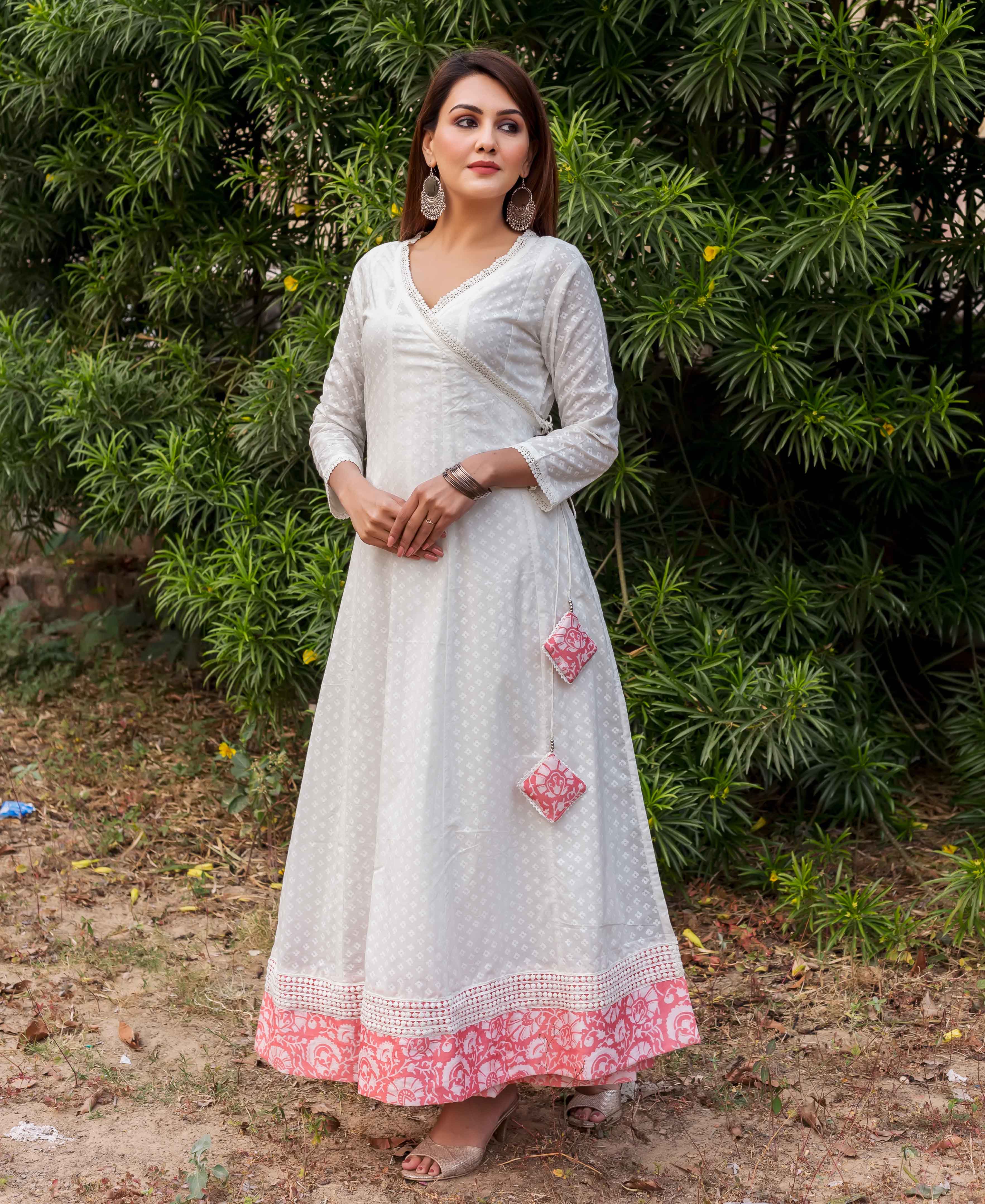 A woman in a white and peach angrakha dress with block print.