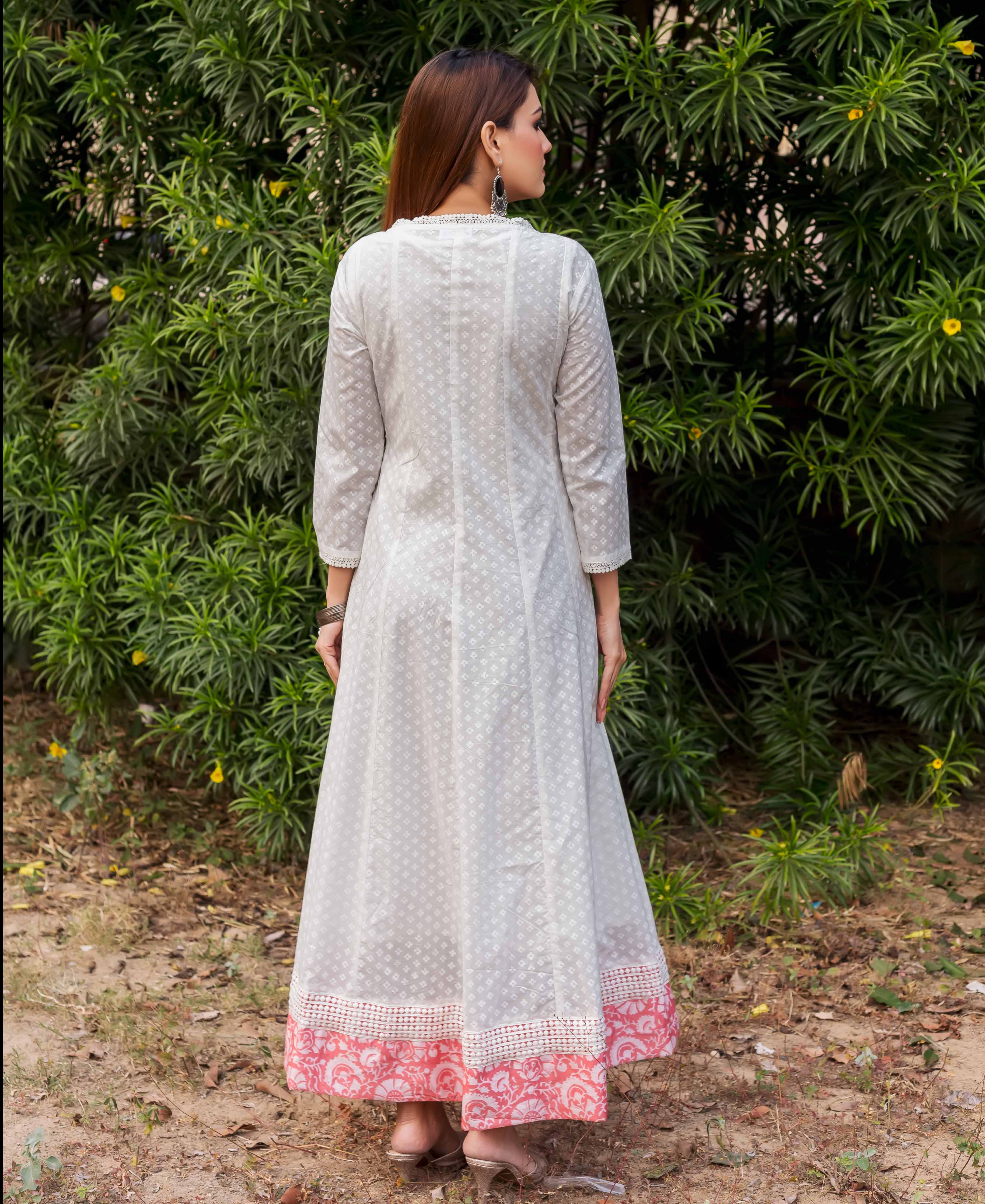 Back view of model in white Angrakha dress with subtle print and peach hand-block border.