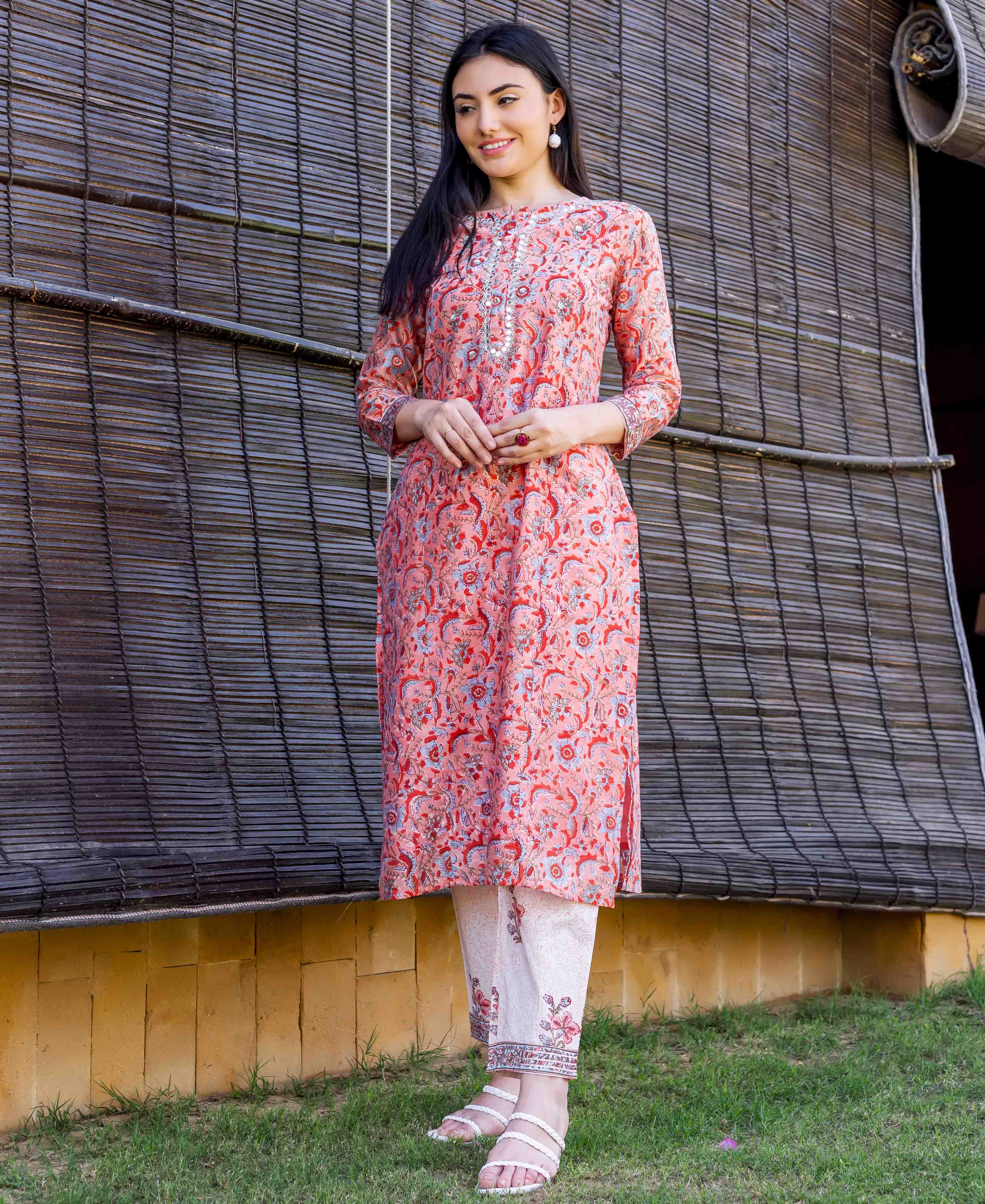 A model wearing a peach block-printed and embroidered straight kurta.