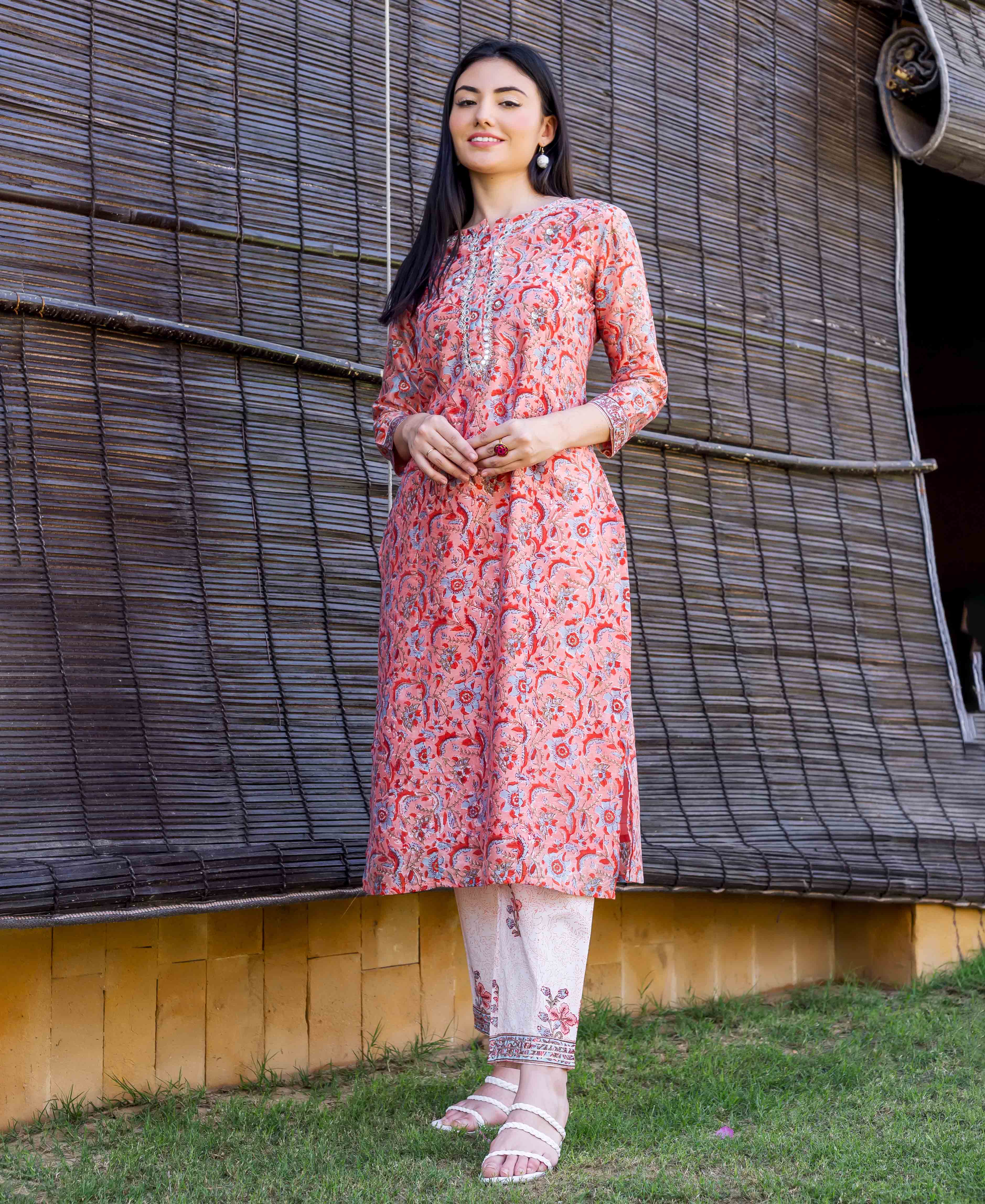 Model wears a peach block-printed, embroidered straight kurta with white printed pants.