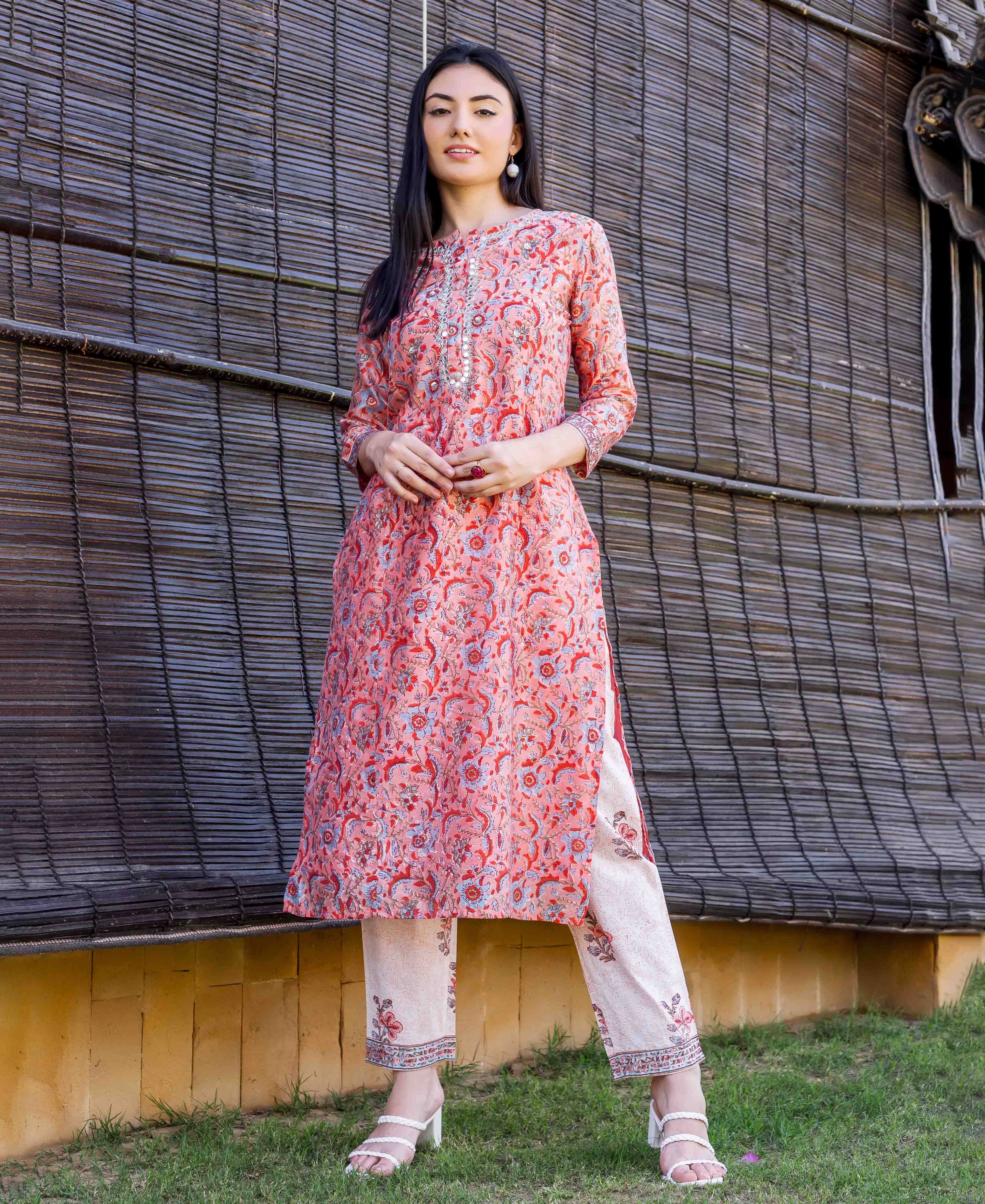 A model wearing a peach block-printed and embroidered straight kurta.