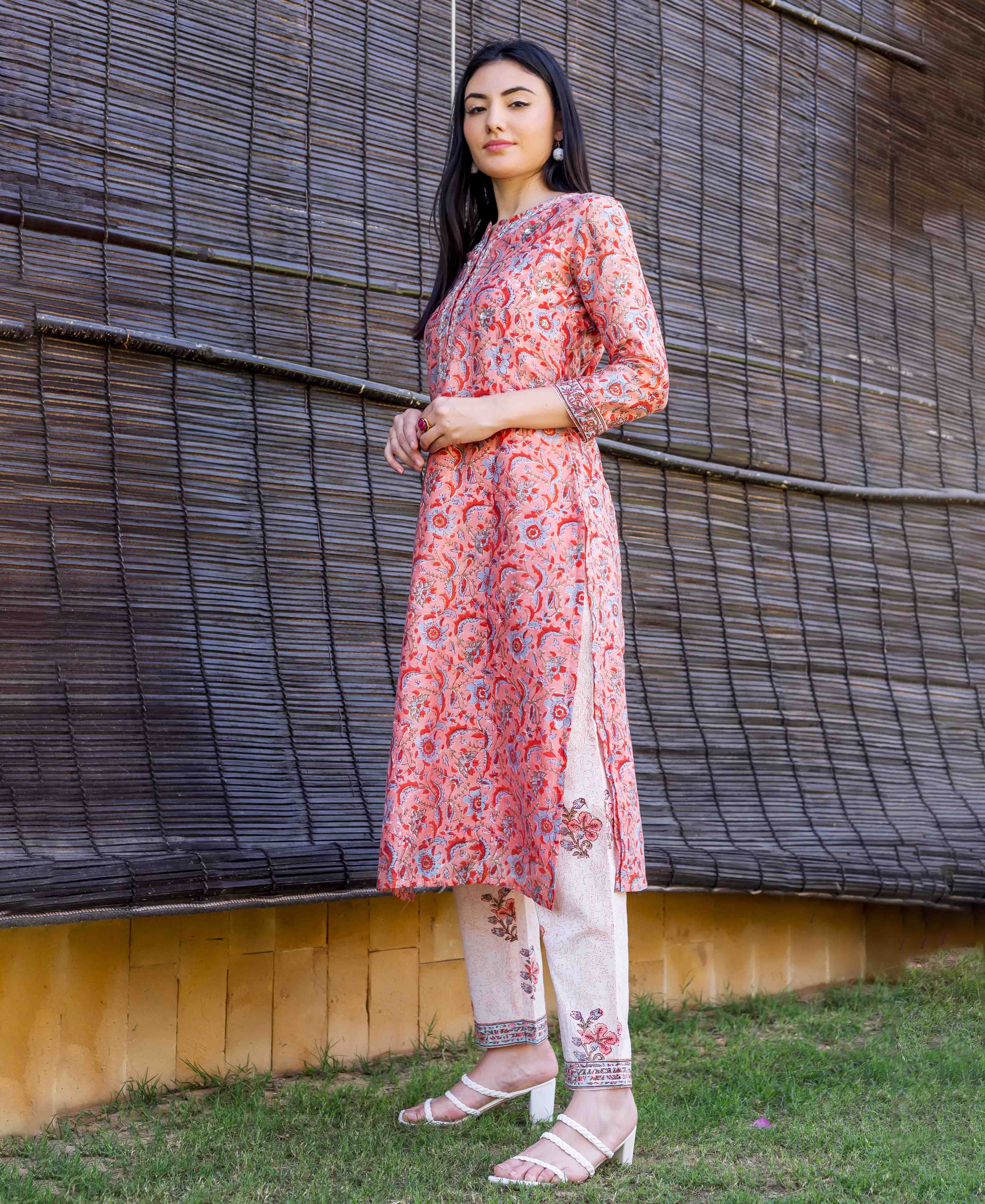 Model wearing a peach block-printed and embroidered straight kurta set, full length.