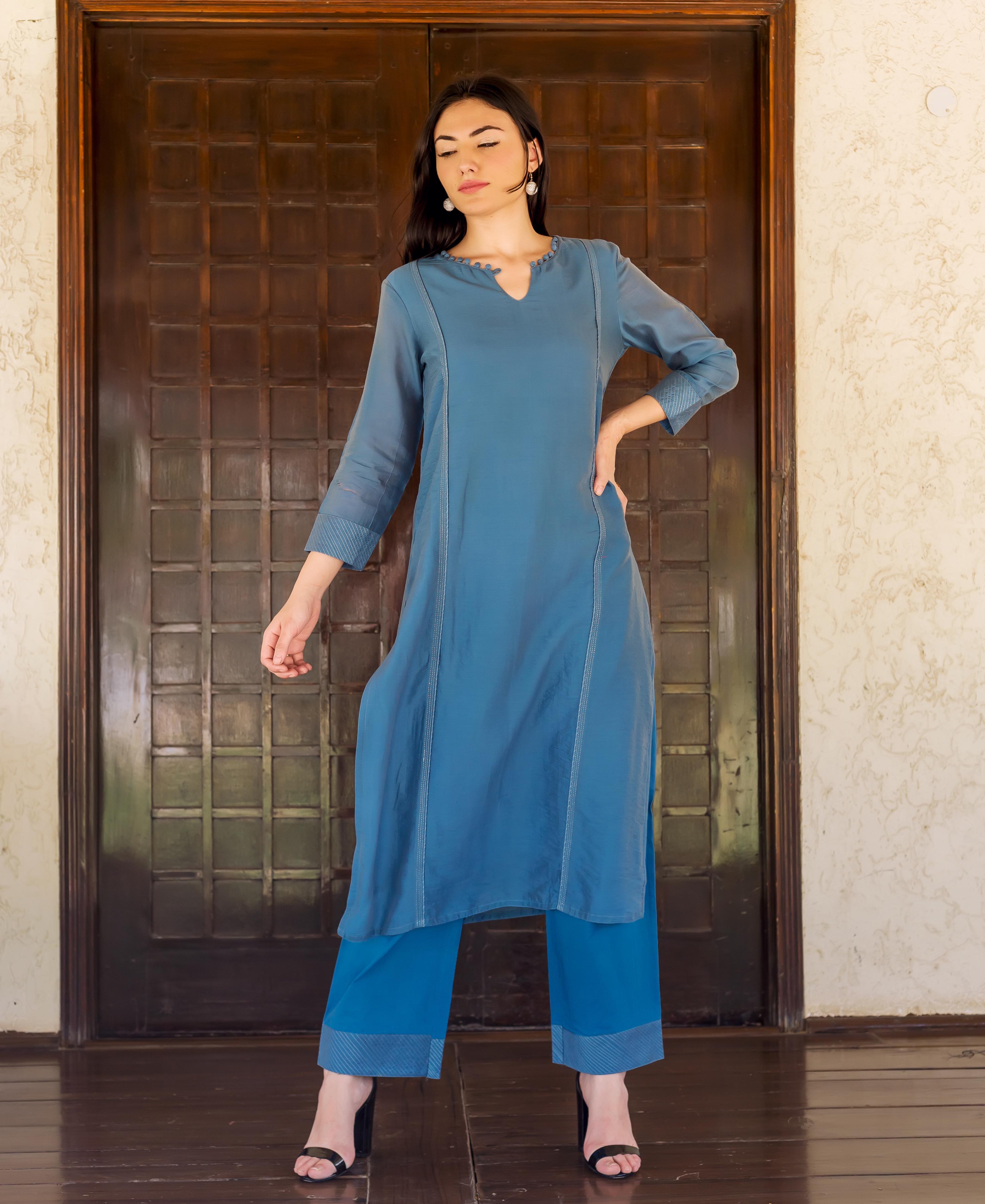 Full length model in Prussian blue kurta set with embroidered details and striped block print.