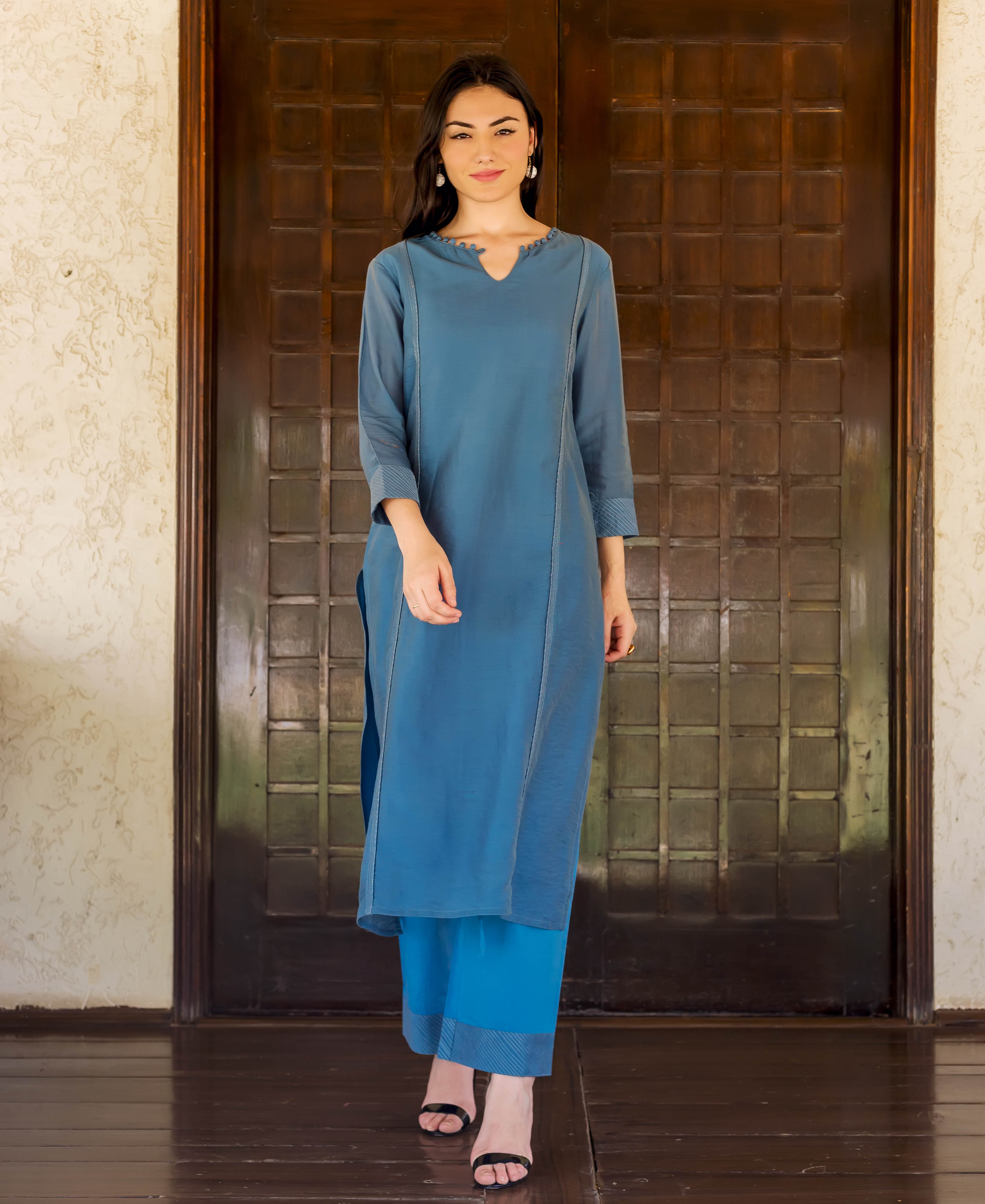 Full-length model in Prussian blue kurta and bright blue palazzo pants with striped hems.