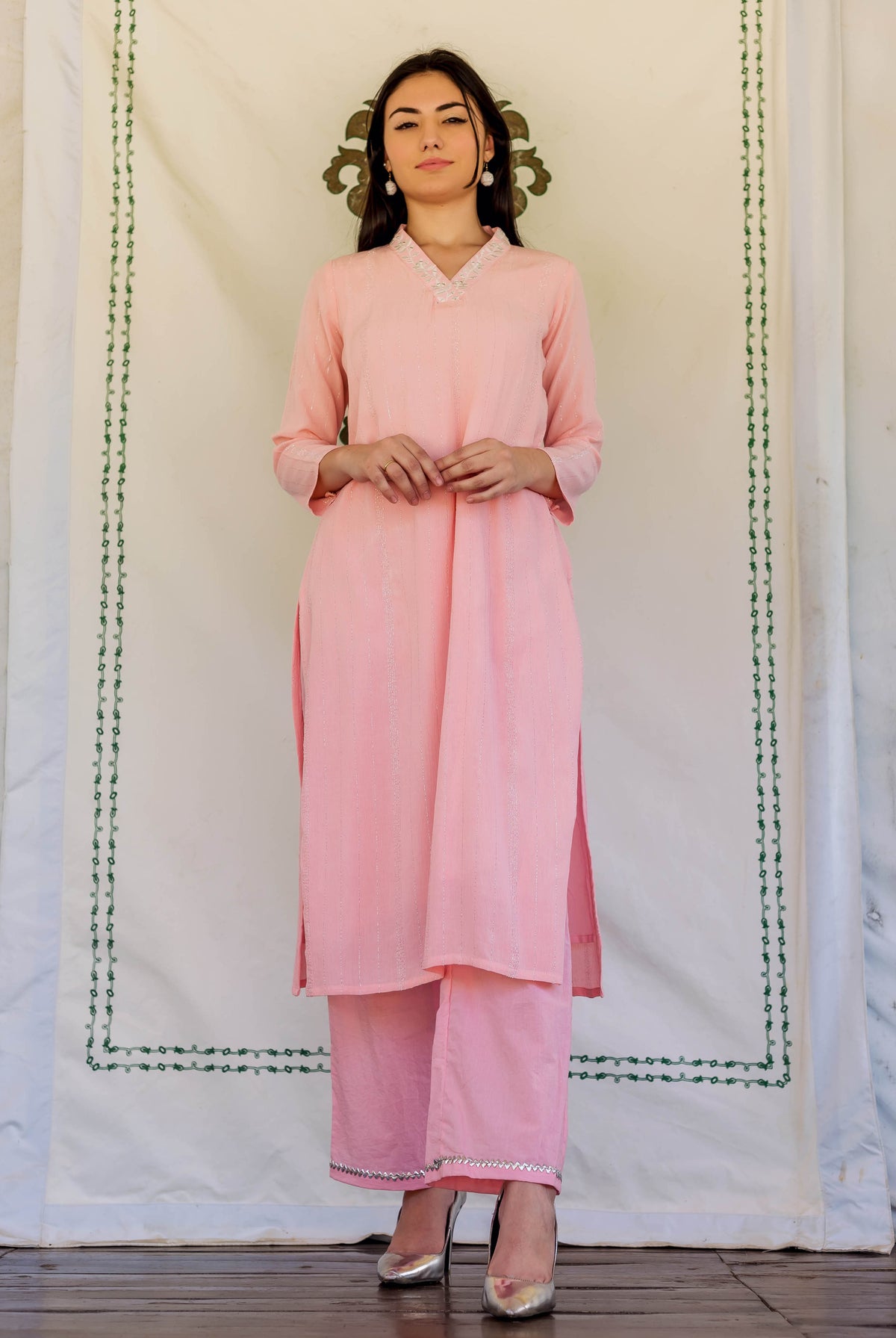Front view of model in pink ethnic straight kurta and pants with embroidery.