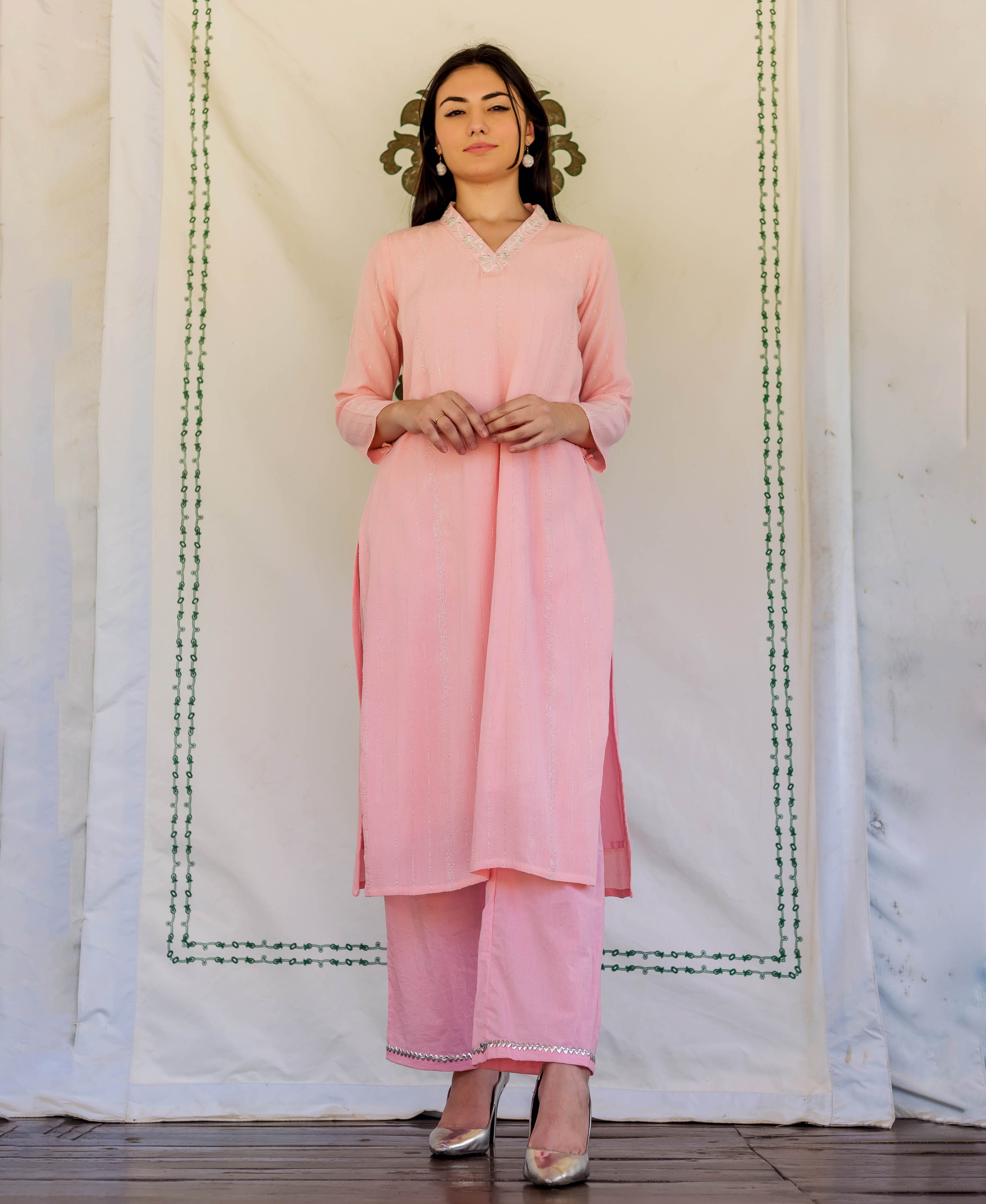 Front view of model in pink ethnic straight kurta and pants with embroidery.