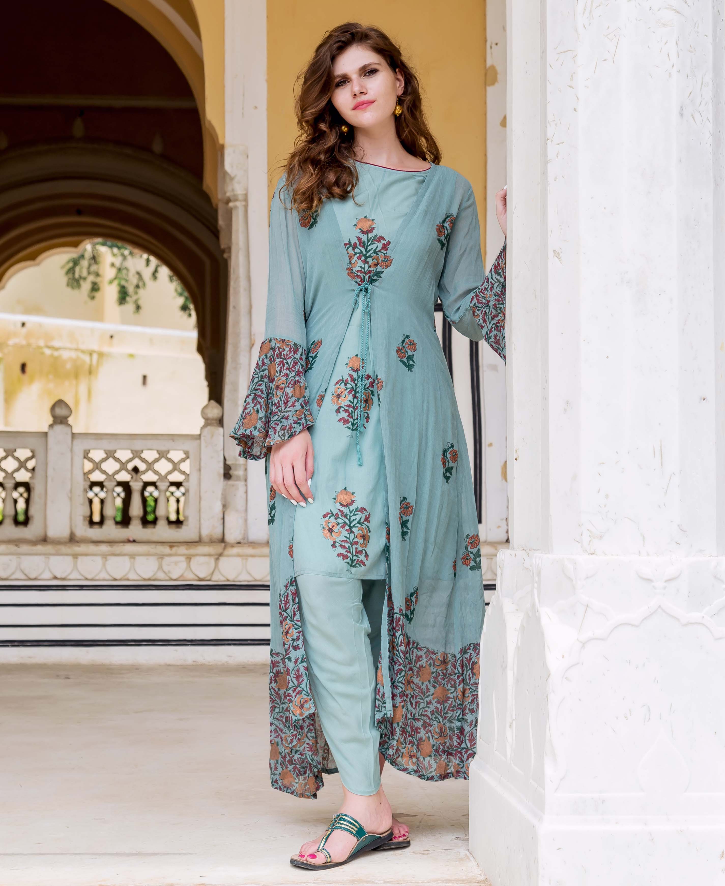 Model wearing Turkish blue hand-block printed dhoti set with long floral jacket, front view.