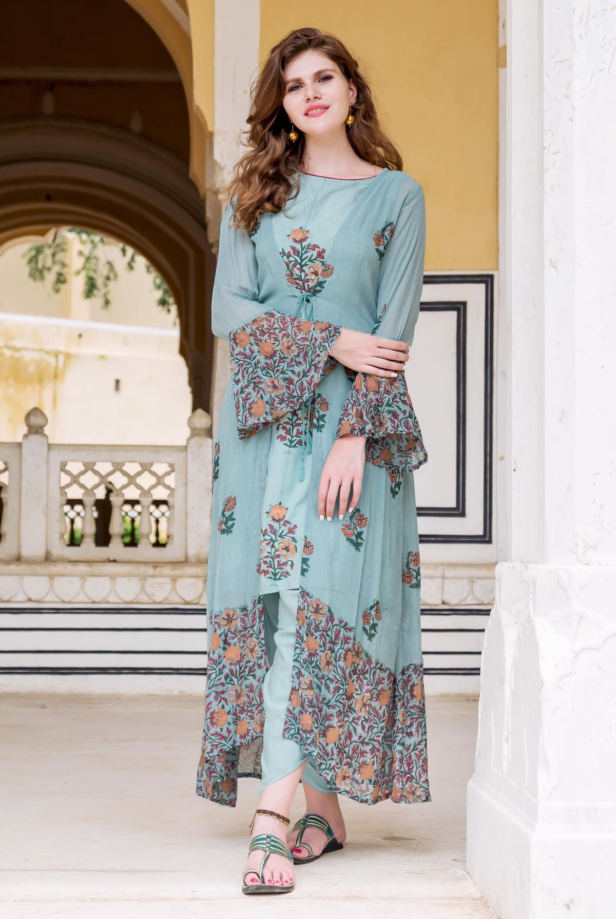 A model wearing a blue floral hand-block-printed dhoti set with jacket.