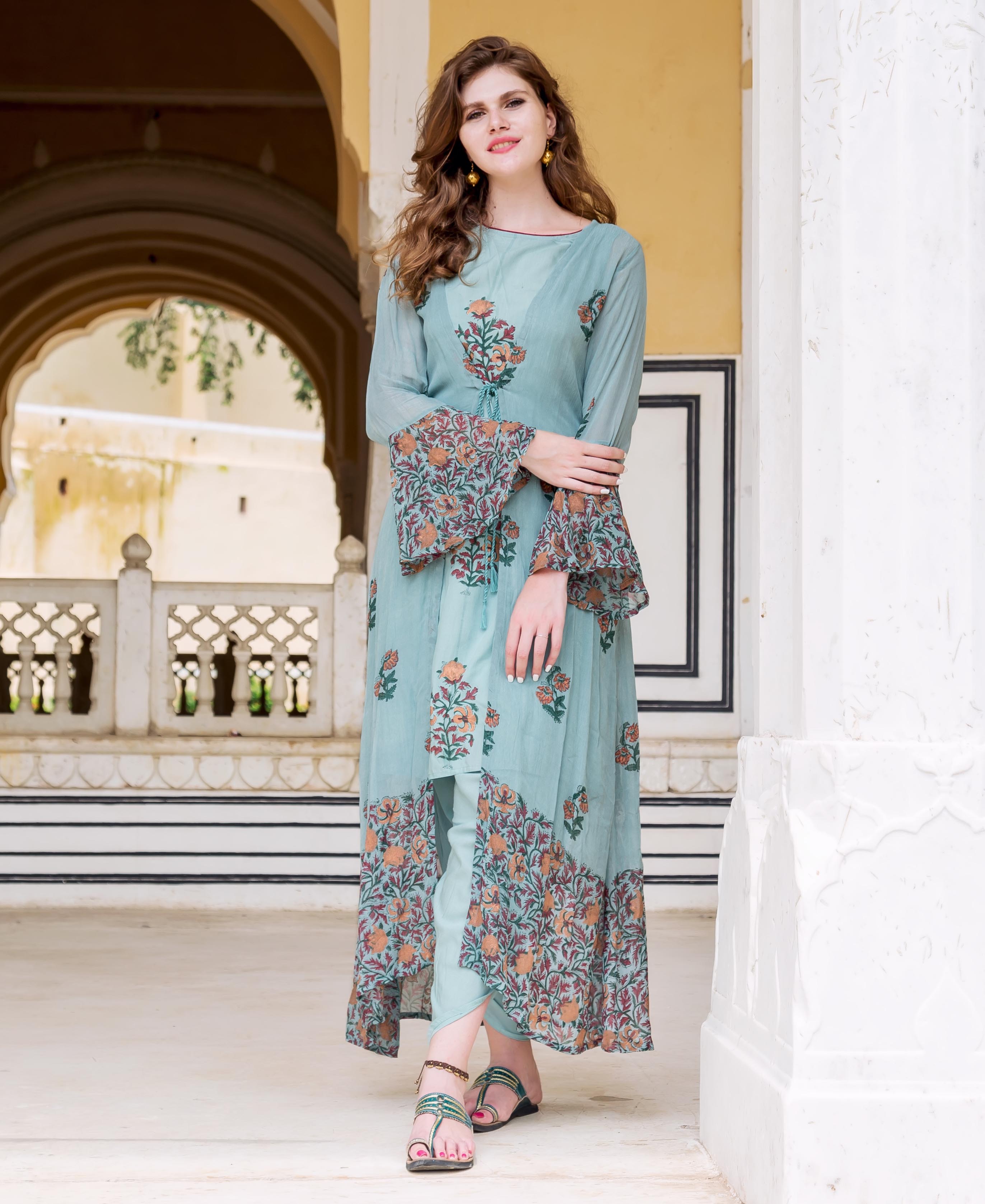 A model wearing a blue floral hand-block-printed dhoti set with jacket.