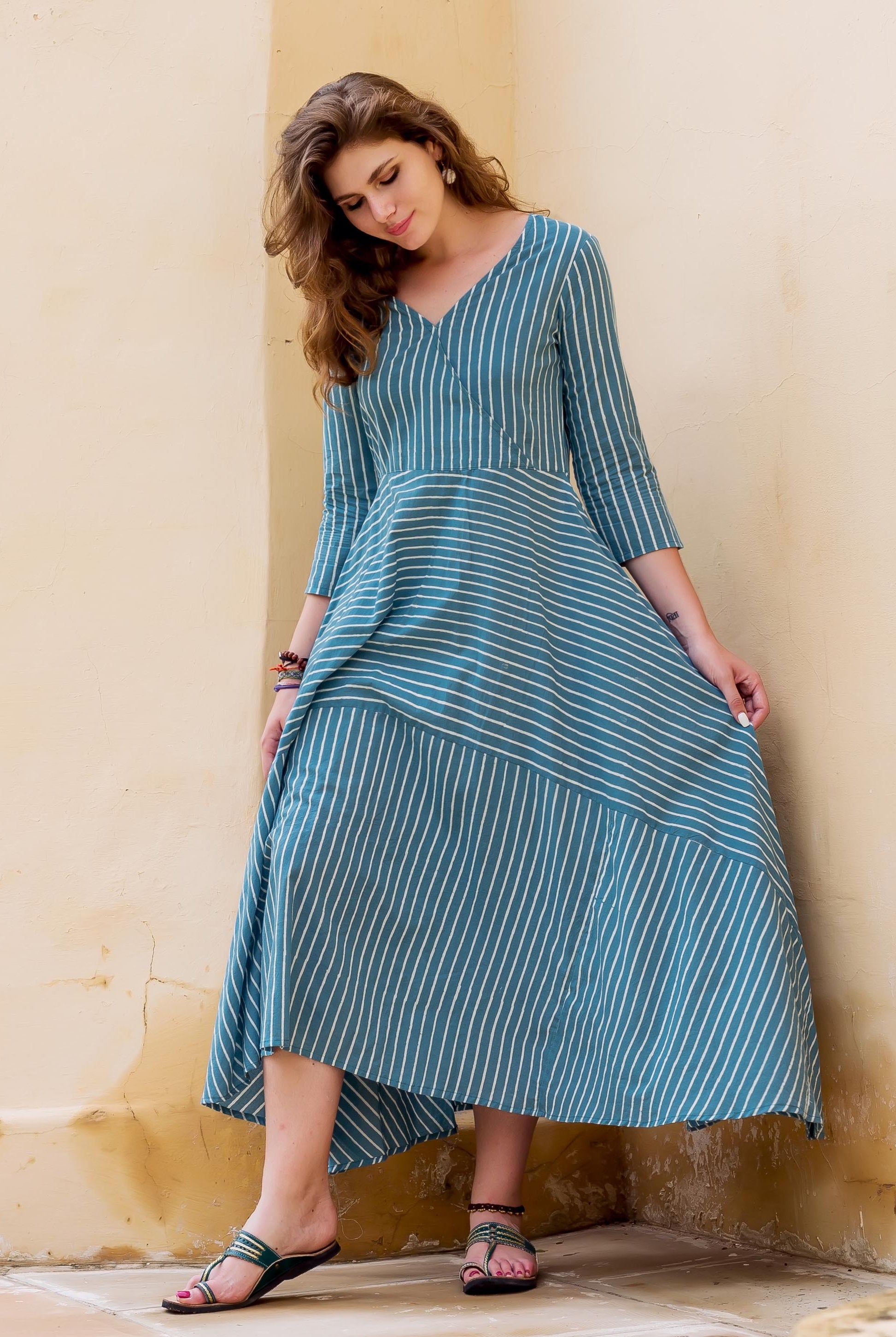 Teal and white striped block printed dress on a model.