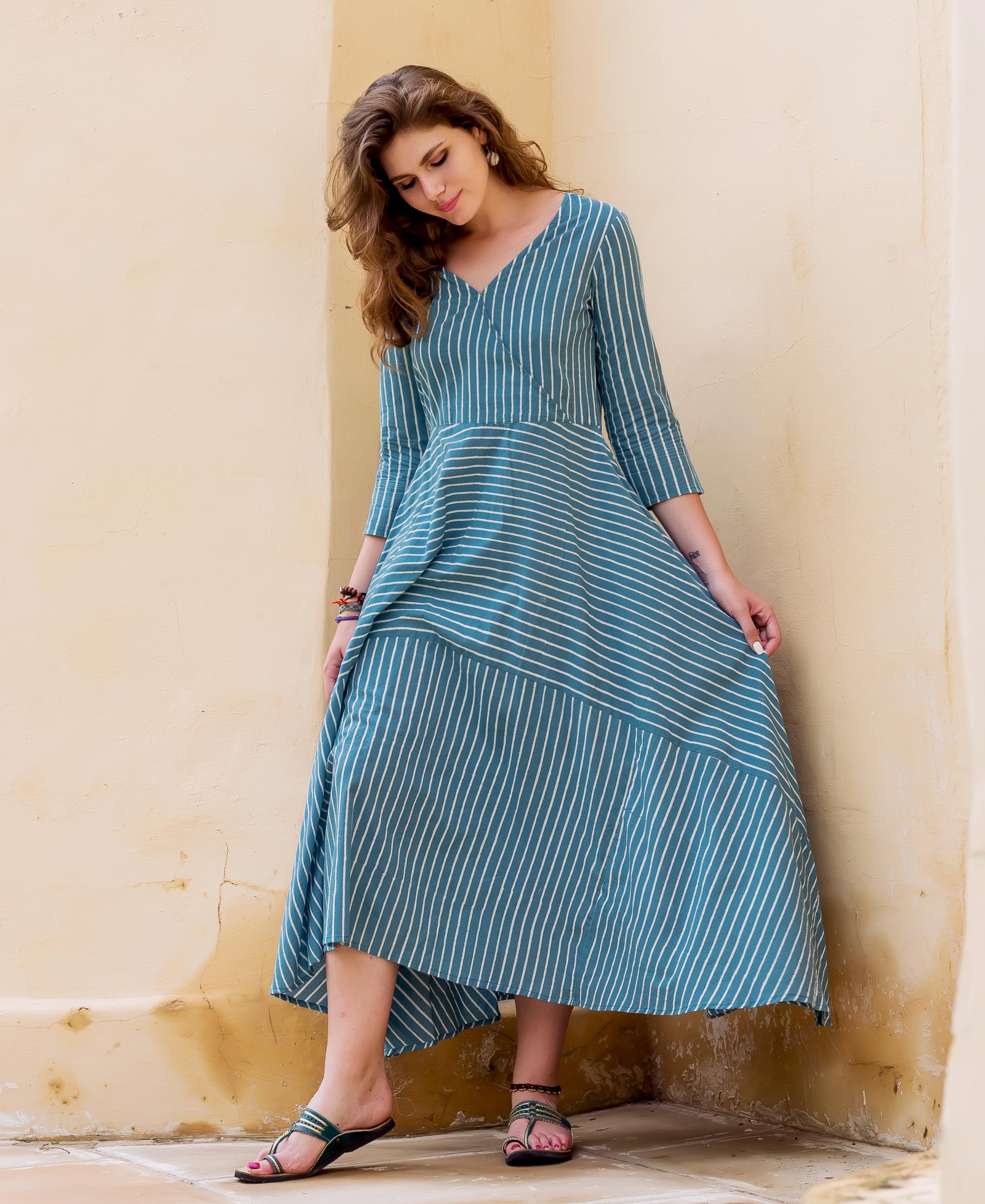 Teal and white striped block printed dress on a model.