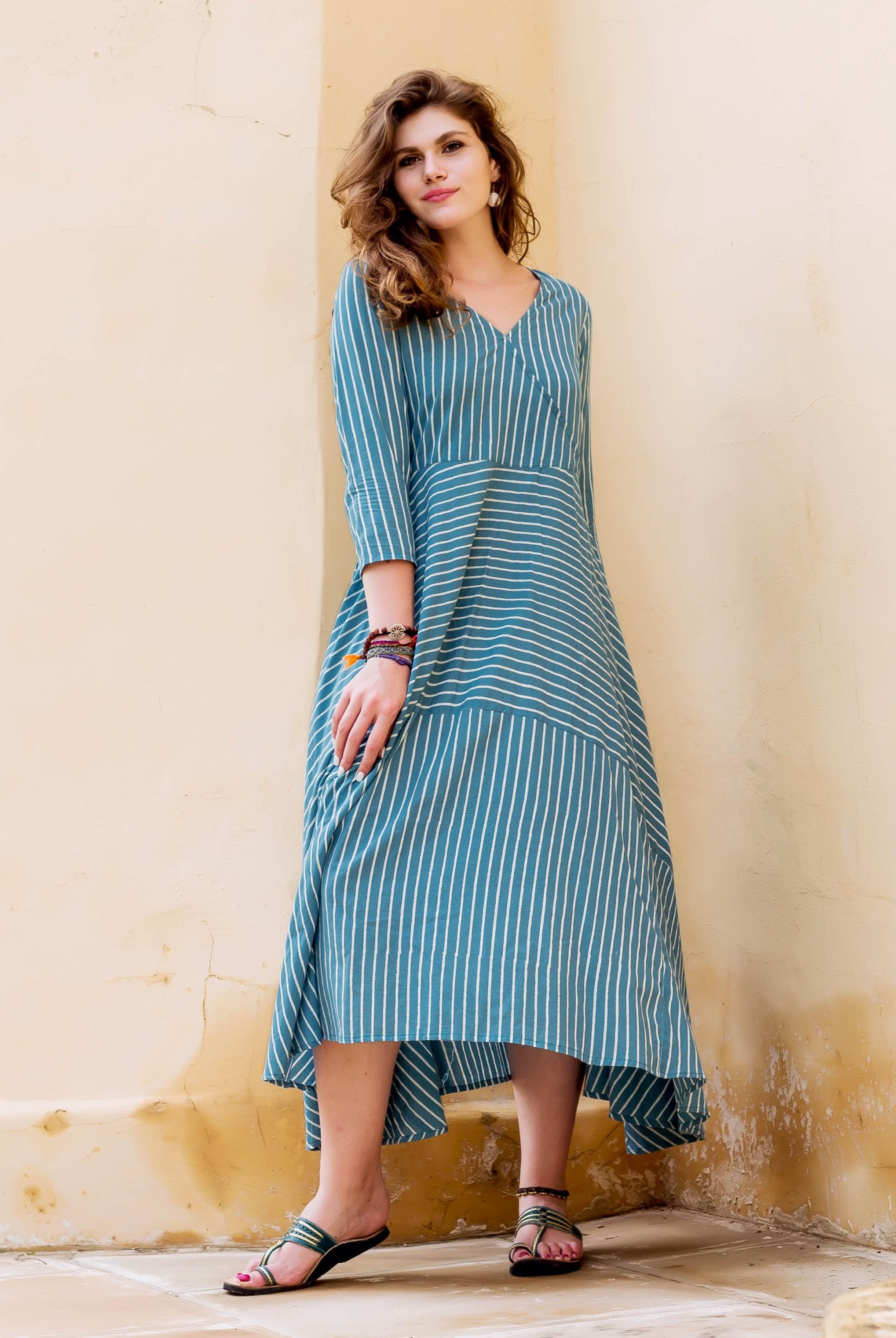 Teal and white striped block printed dress on a model.