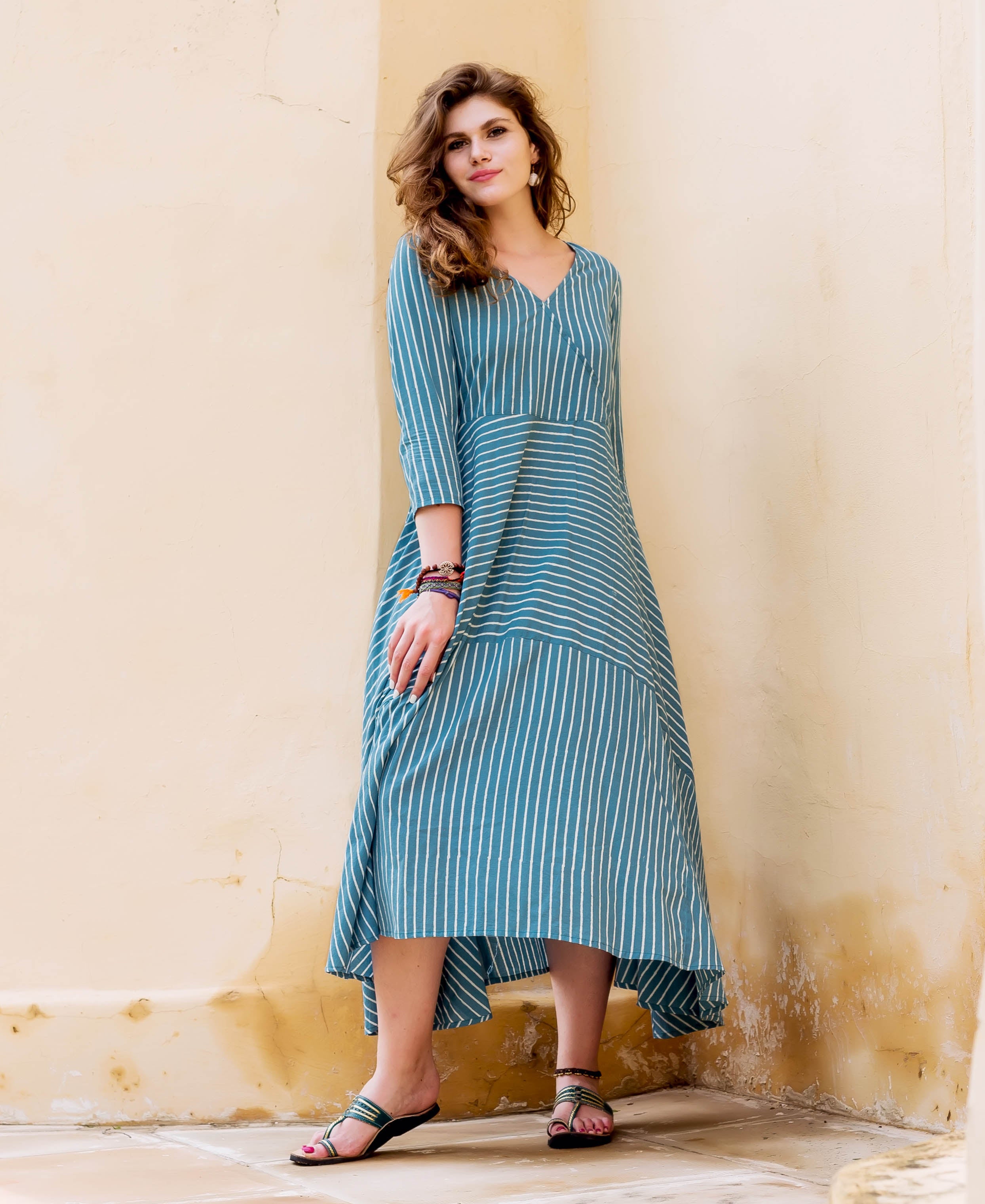 Teal and white striped block printed dress on a model.