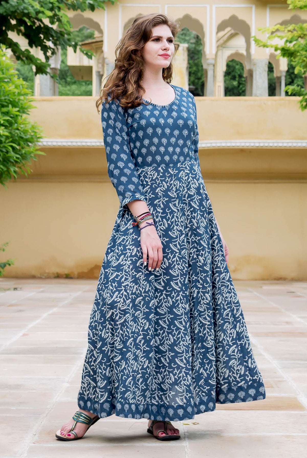 Full-length front view of model in an indigo hand-block-printed ethnic flared dress.