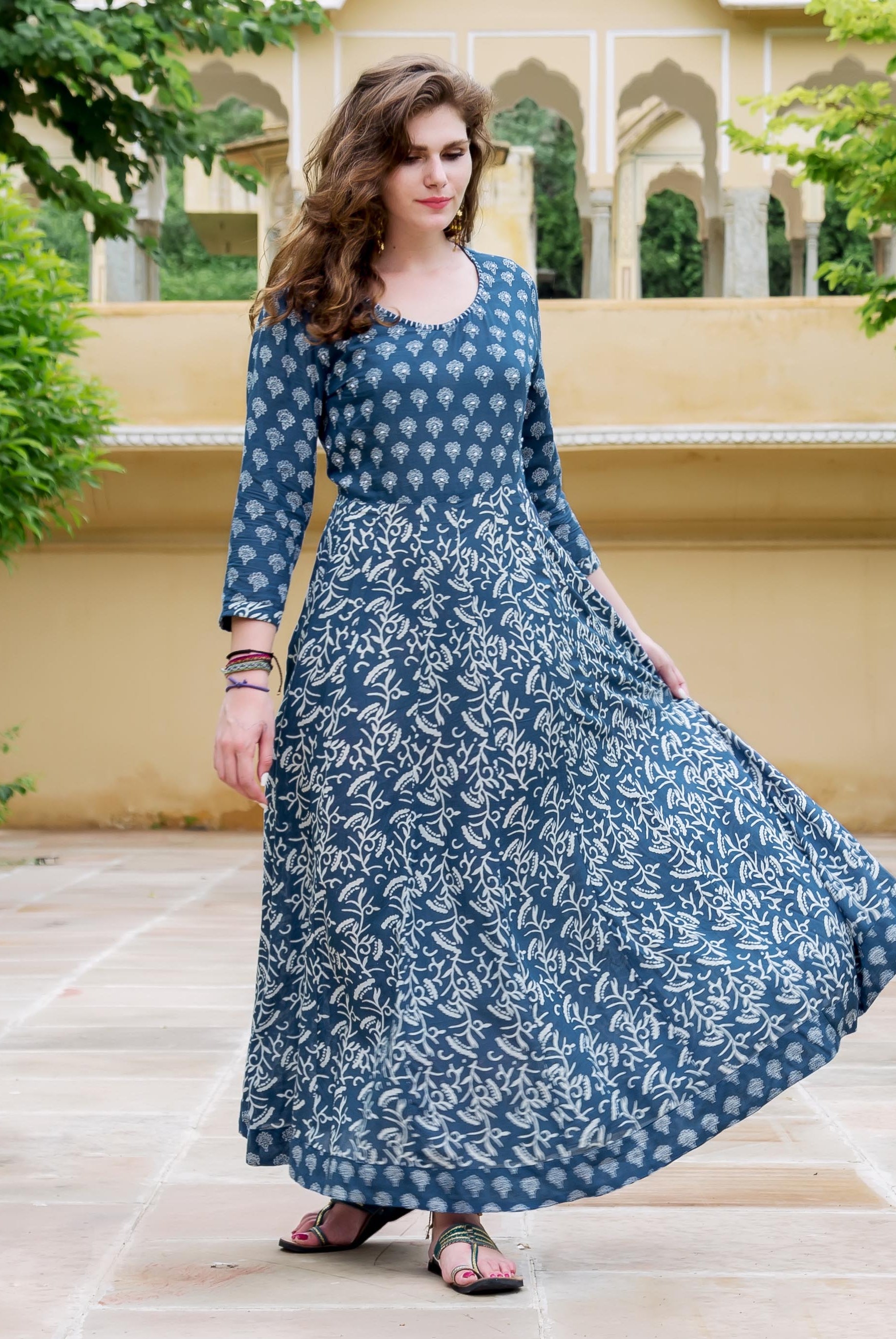 A model wearing a blue and white printed flared dress.