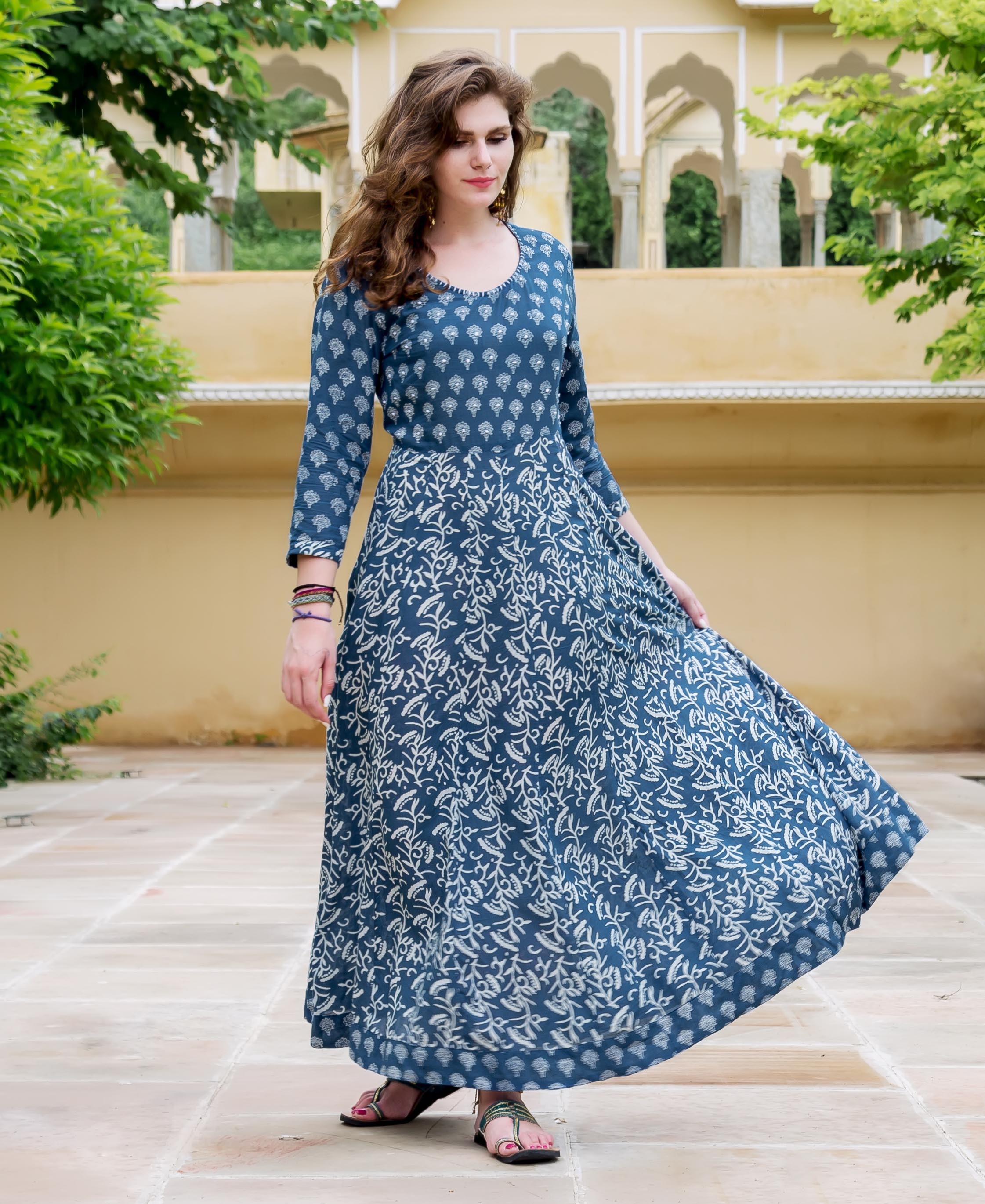 A model wearing a blue and white printed flared dress.