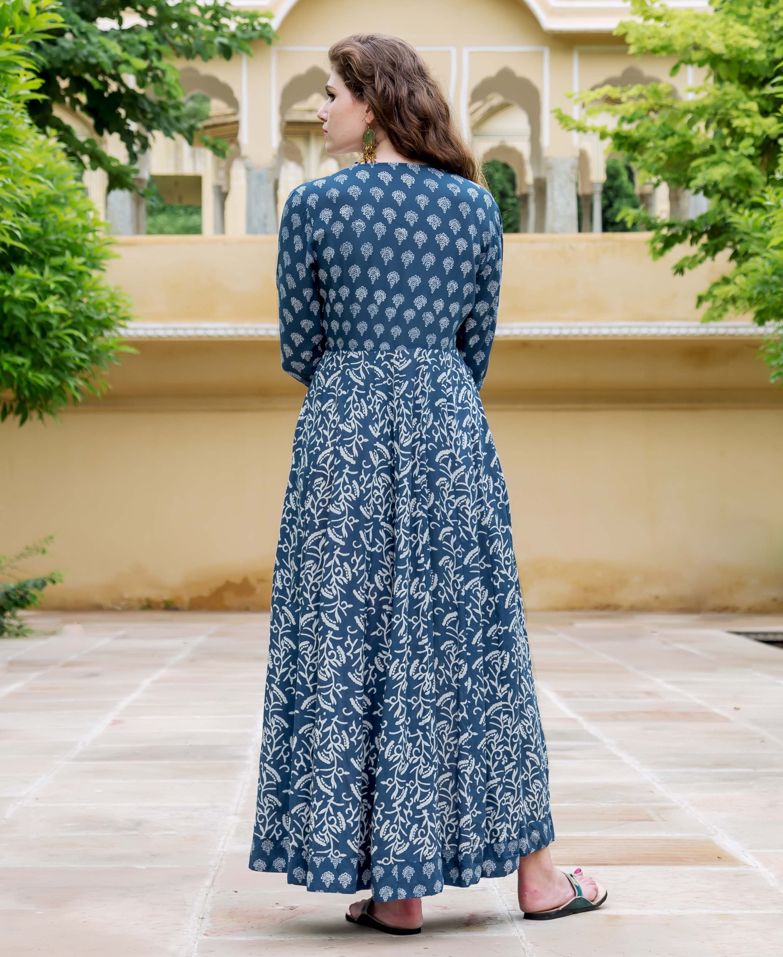 Back view of model in full indigo hand-block-printed flared dress with distinct patterns.