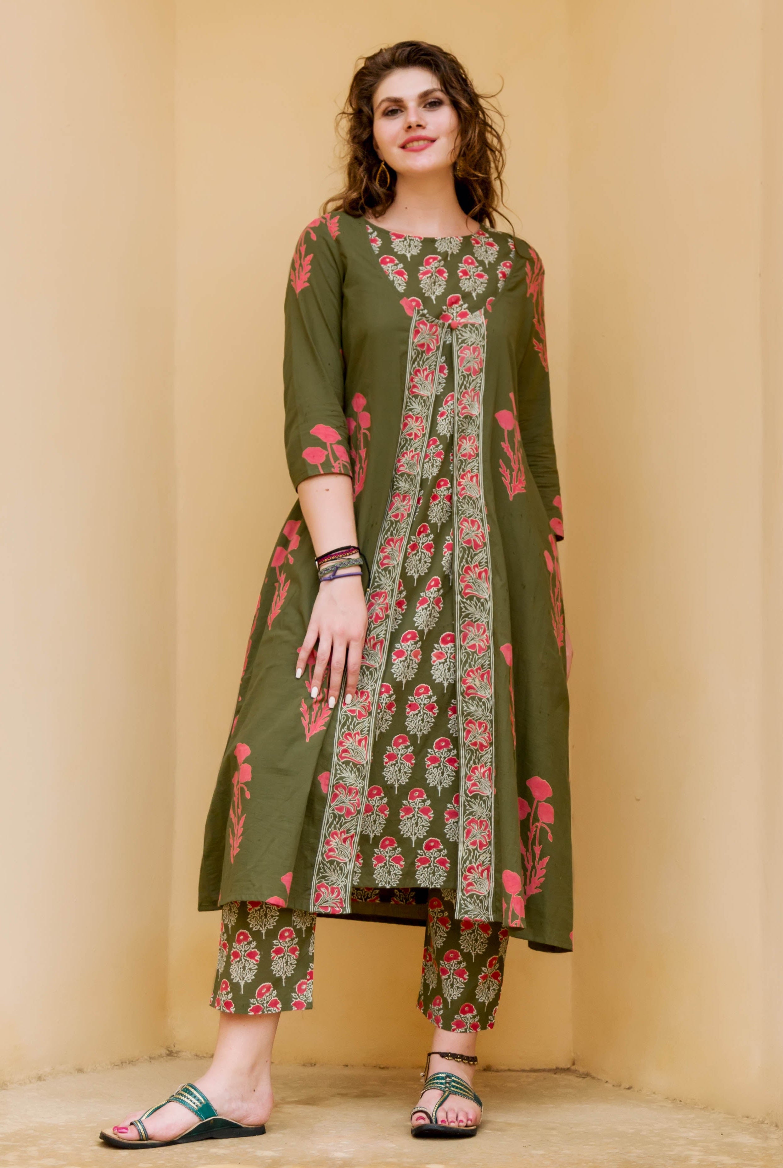 Olive green and red hand-block-printed kurta set with detachable jacket, on a female model.