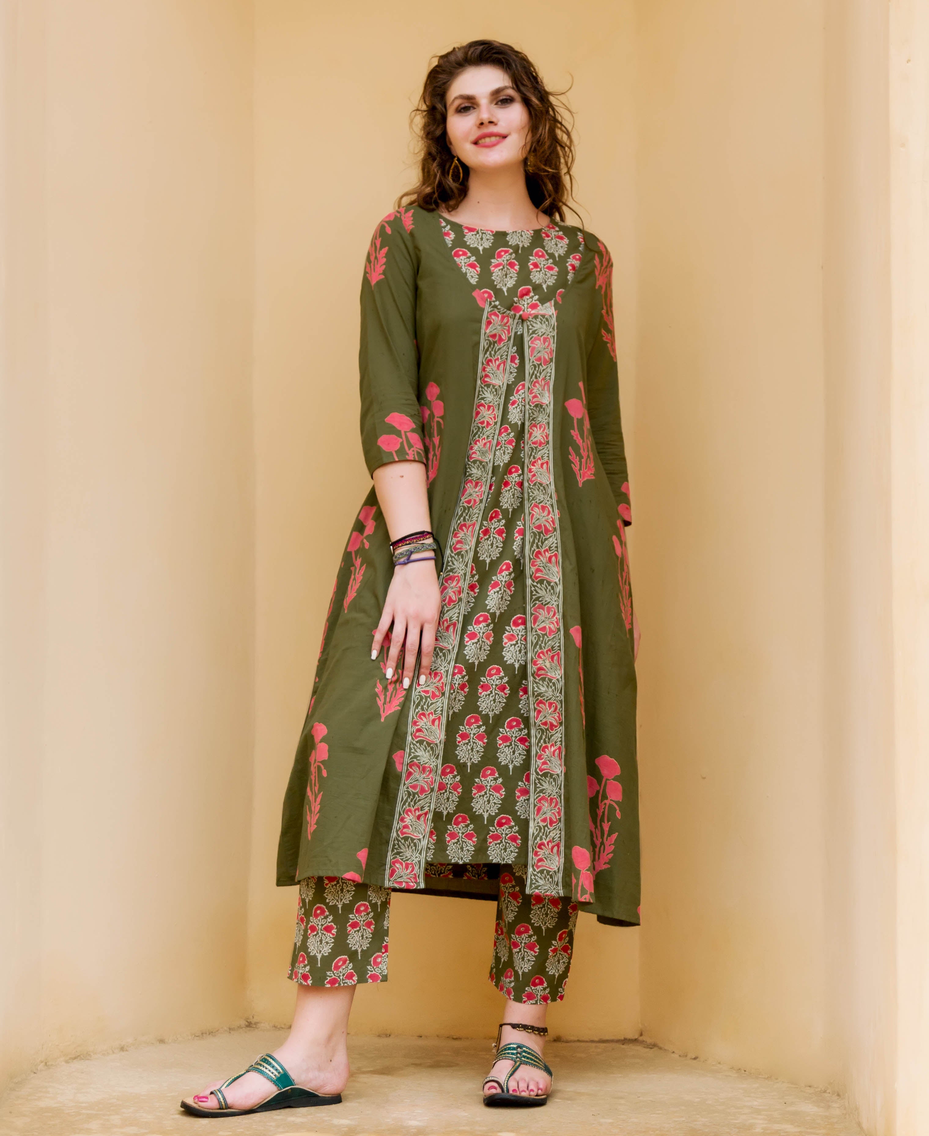 Olive green and red hand-block-printed kurta set with detachable jacket, on a female model.