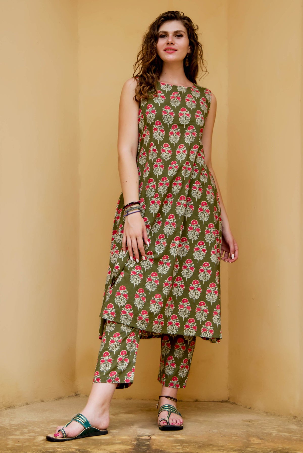Full-length model in olive green and red floral hand-block-printed ethnic kurta set.