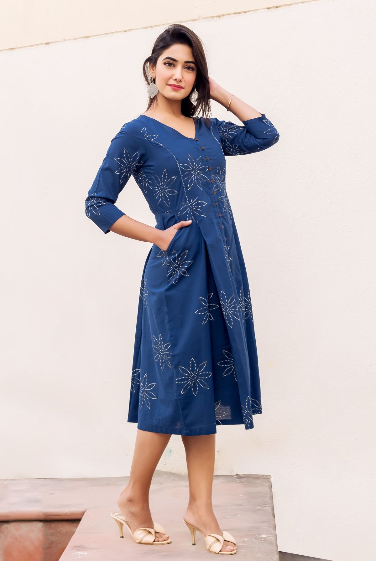 Front view of model in full indigo button-down dress with white floral block print.