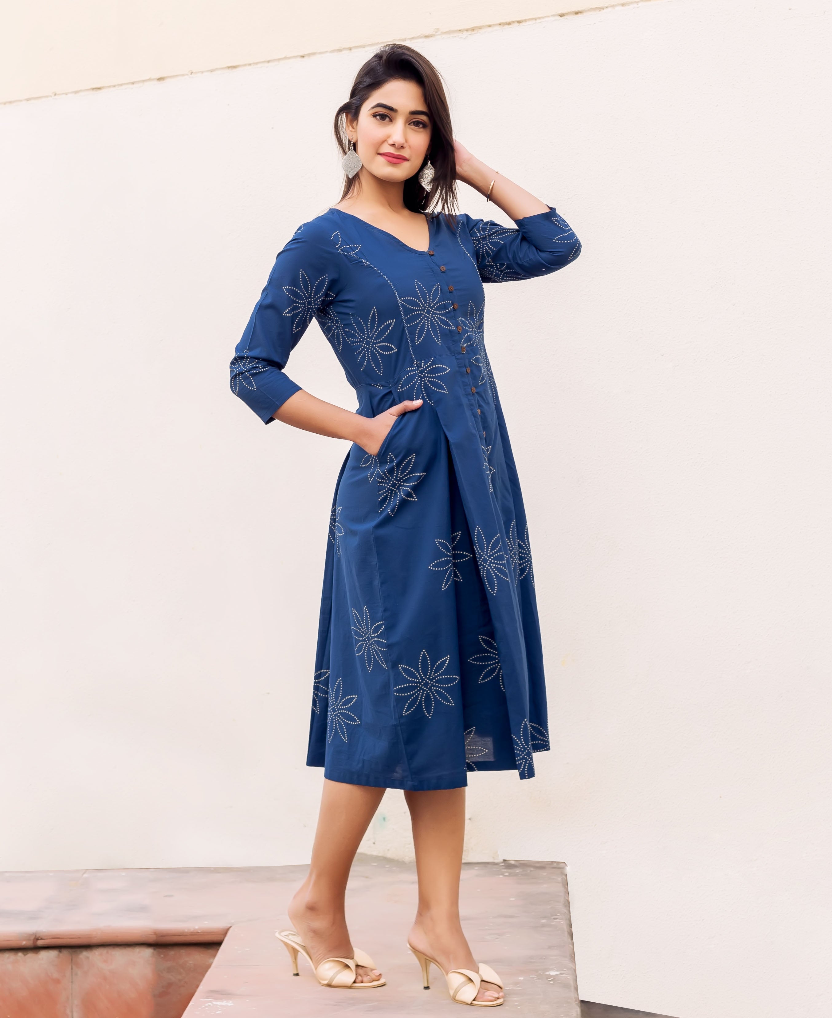 Front view of model in full indigo button-down dress with white floral block print.