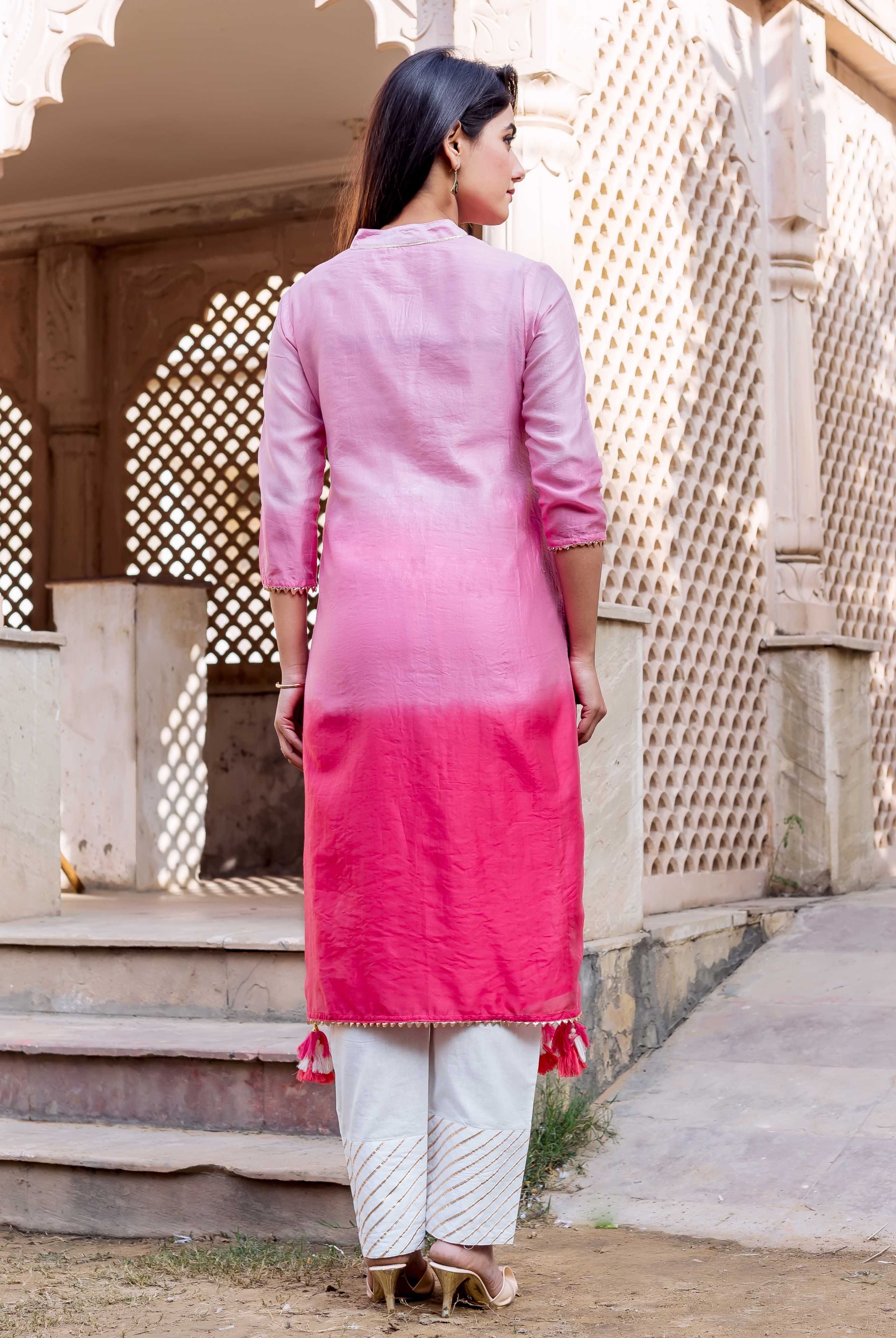Back view of model in ombre pink kurta and white hand-block printed gold stripe pants.